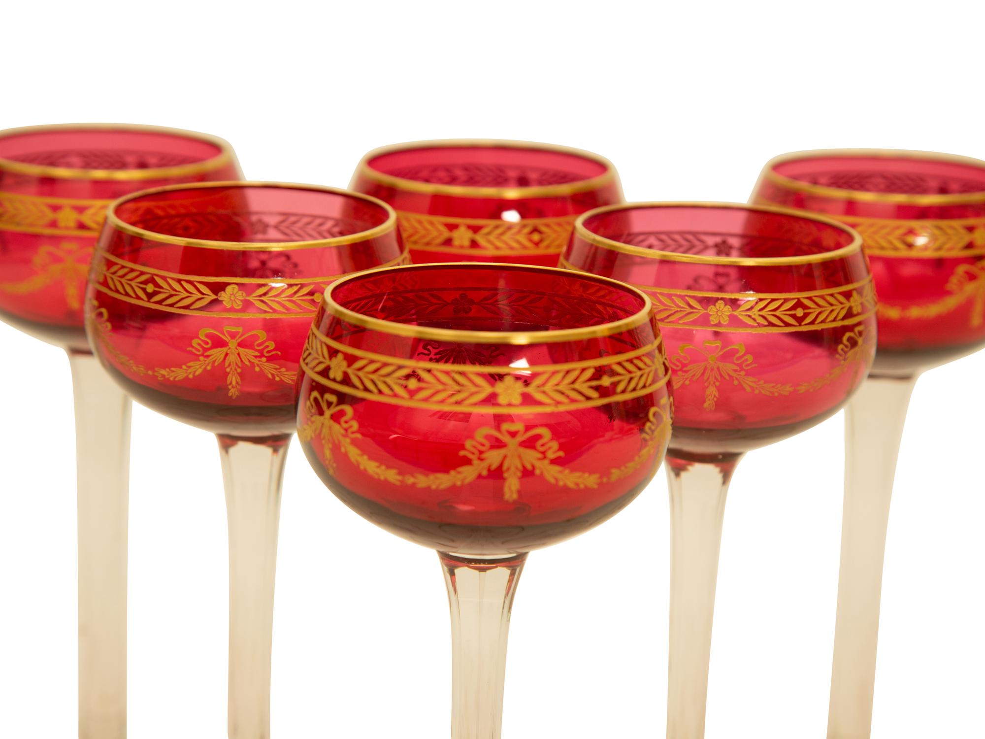 A Set of Twelve Bohemian Gilt Decorated Cranberry Glass Stemmed White Wines — 19th/20th Century