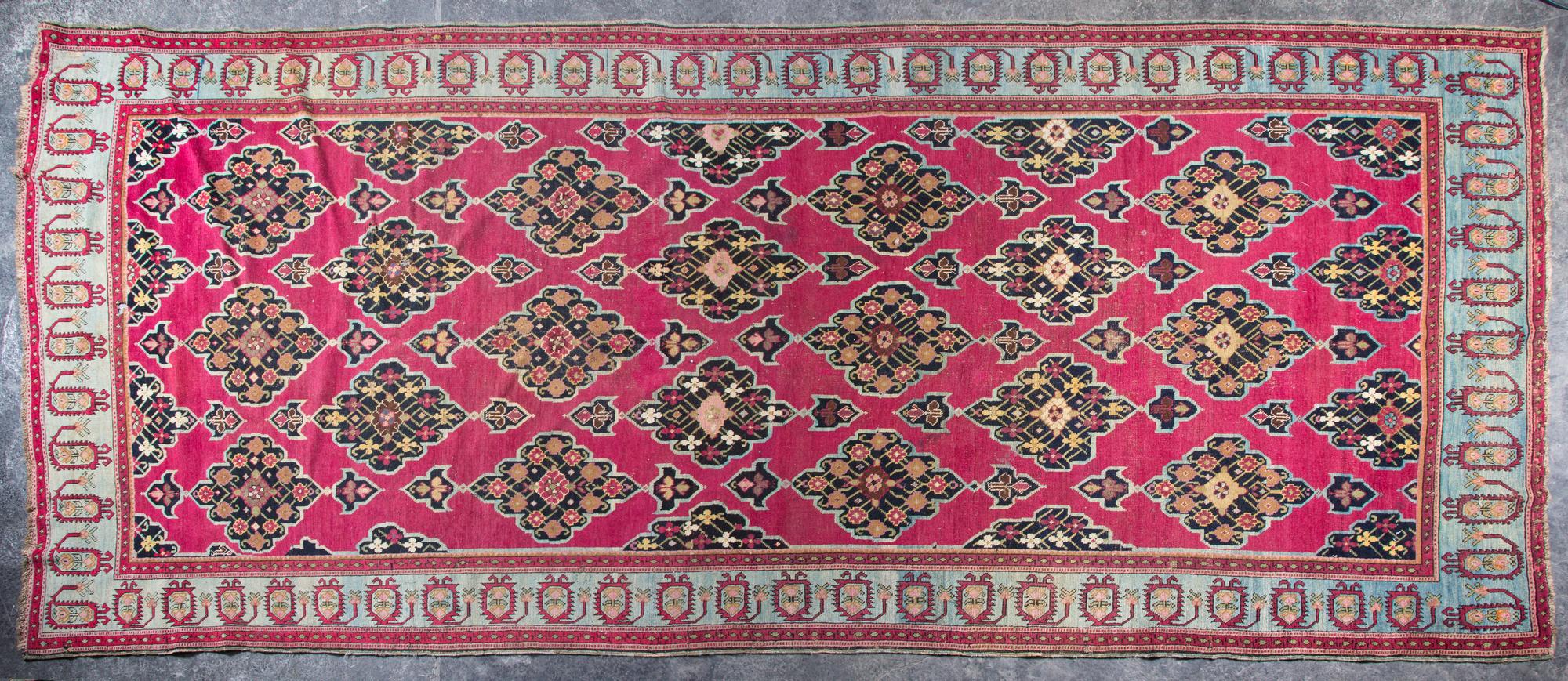 A Wool Rug 12 feet 3 inches x 5 feet 4 inches.
