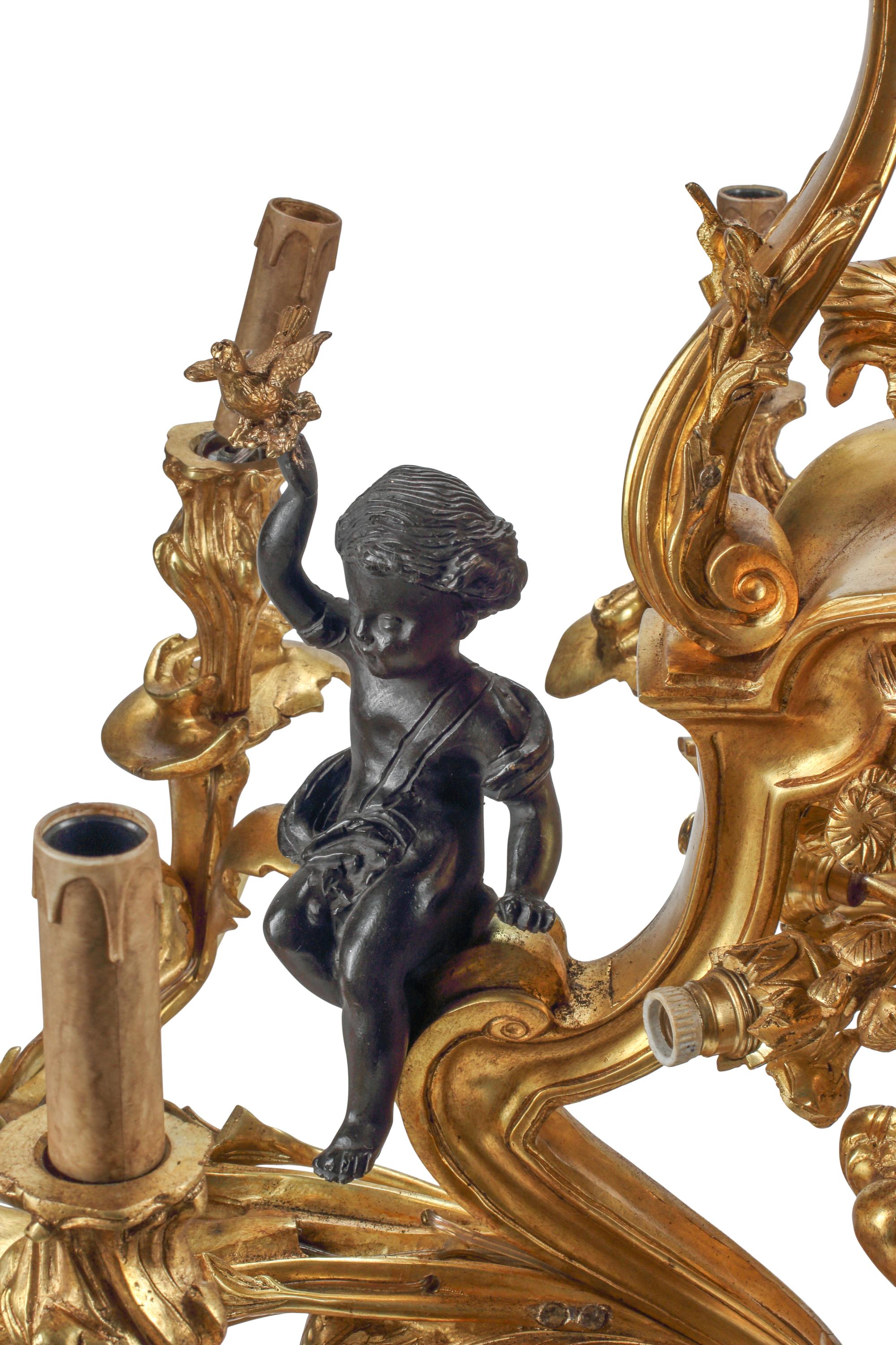 A Louis XV Style Gilt and Patinated Bronze Nine-Light Chandelier