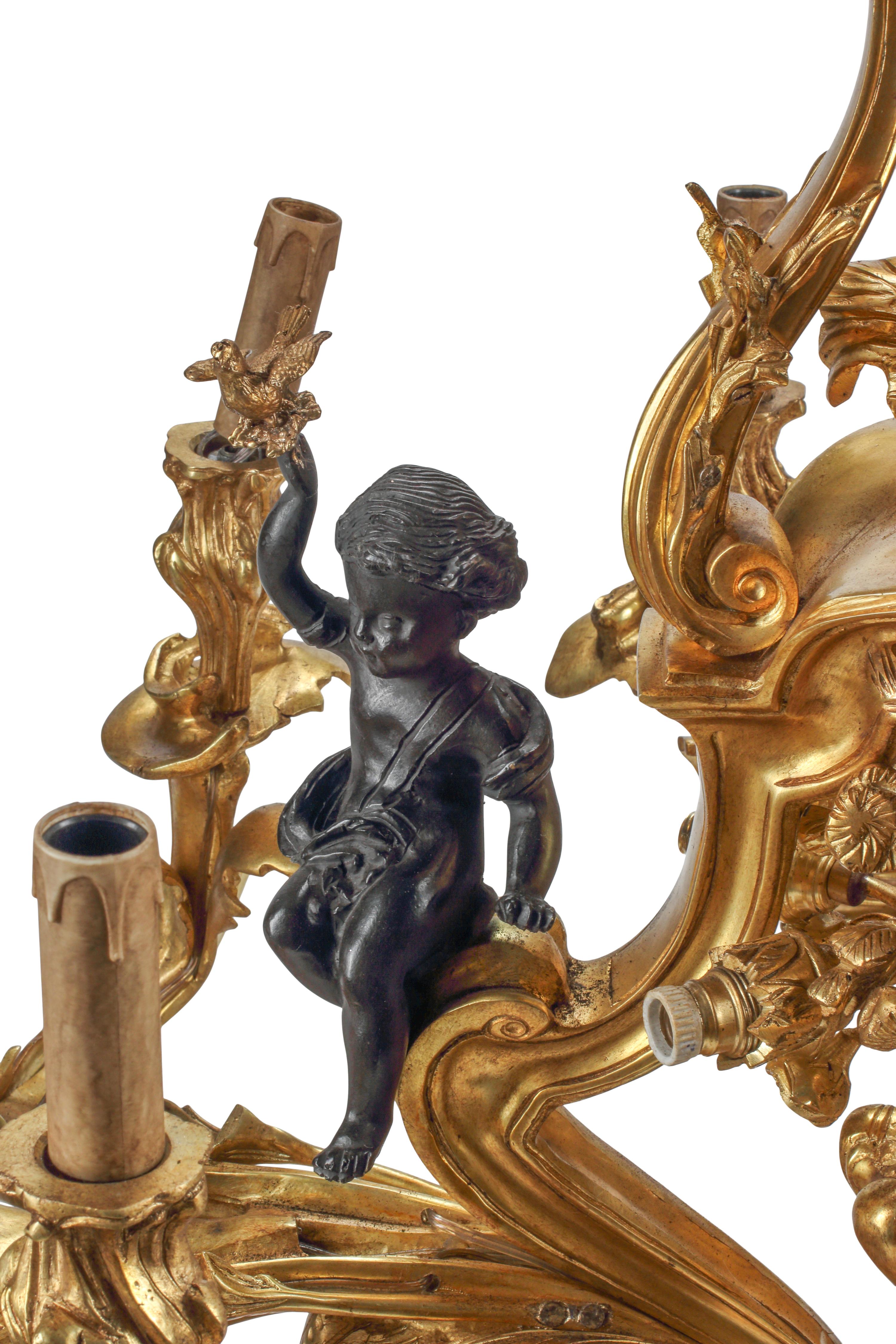 A Louis XV Style Gilt and Patinated Bronze Nine-Light Chandelier
