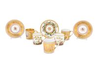 A Group of French Painted Porcelain Coffee Cups and Saucers