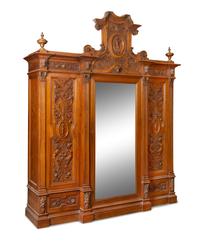 An Italian Renaissance Revival Carved Walnut Armoire