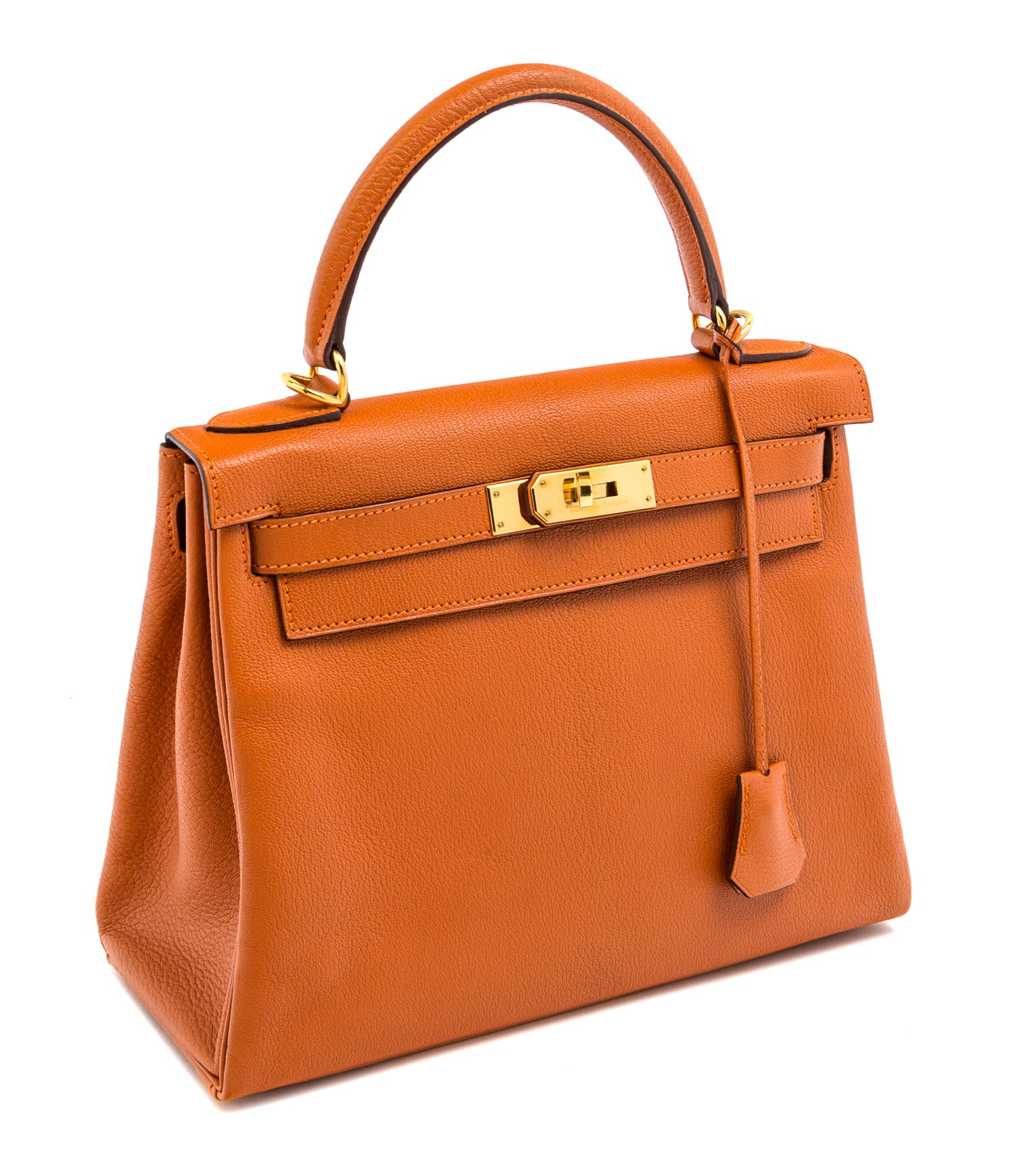 An Hermes Orange Retourne 28cm Kelly Handbag, 11" x 8.5" x 4"; Handle drop: 3.5".