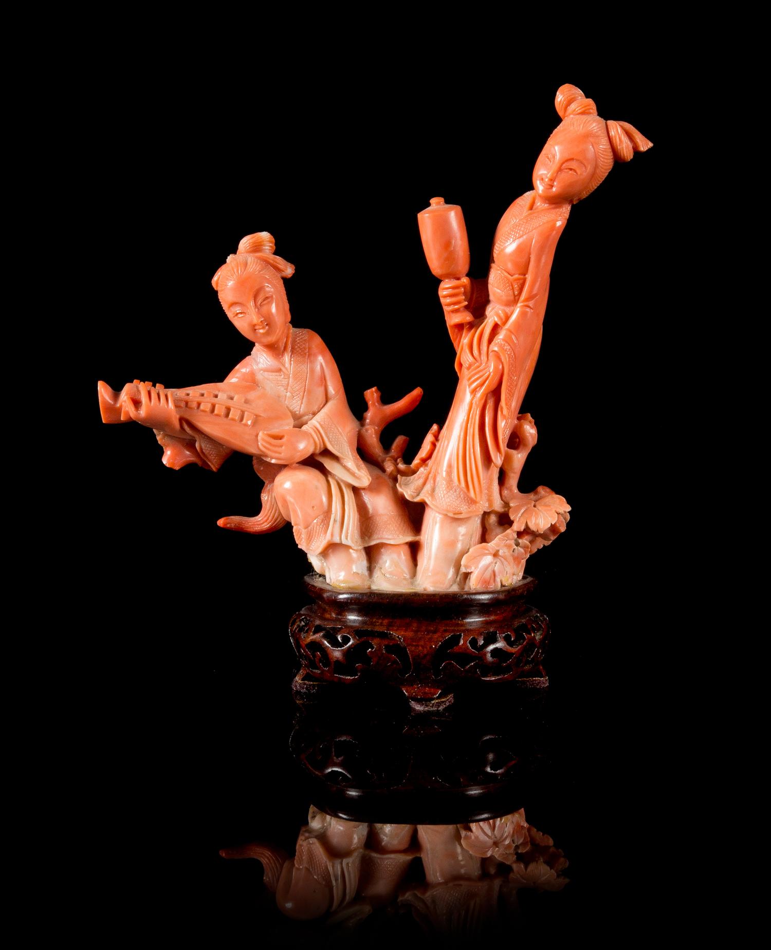 A Pink Coral Figural Group of Two Female Musicians Height 4 3/4 inches.