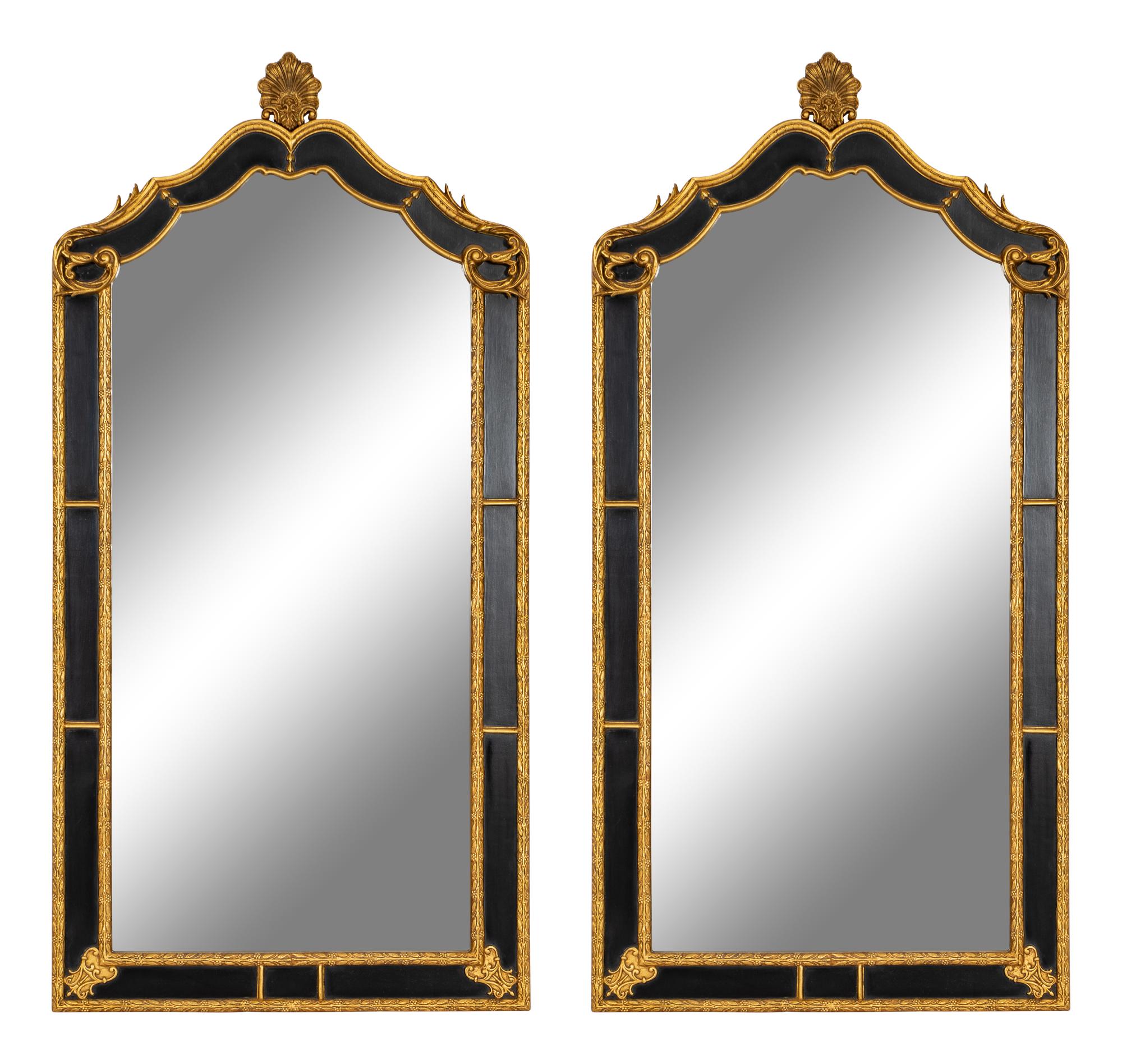 A Pair of Large Ebonized and Parcel Gilt Pier Mirrors
