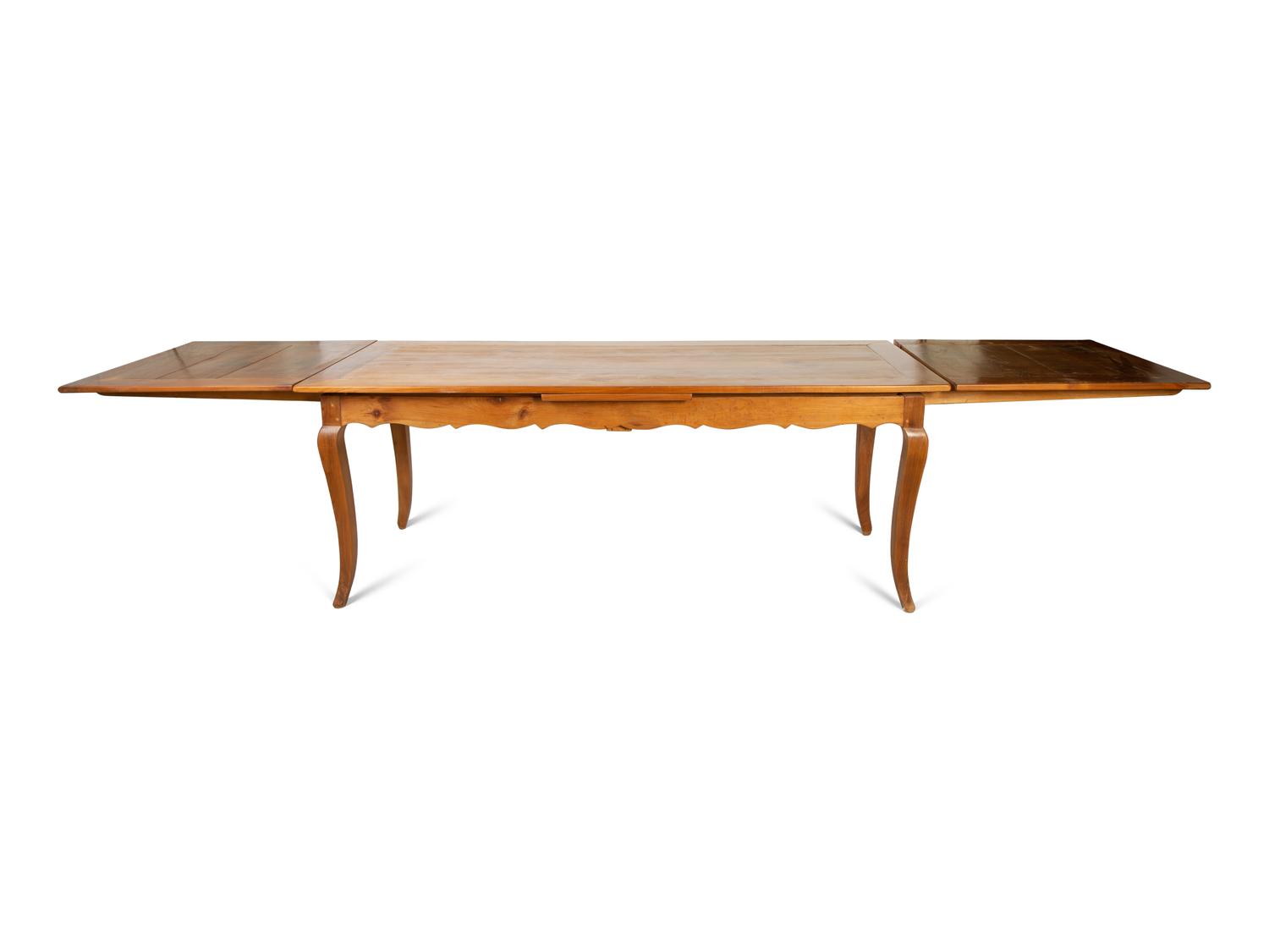 A French Provincial Style Fruitwood Dining Table and Six Side Chairs — 20TH CENTURY