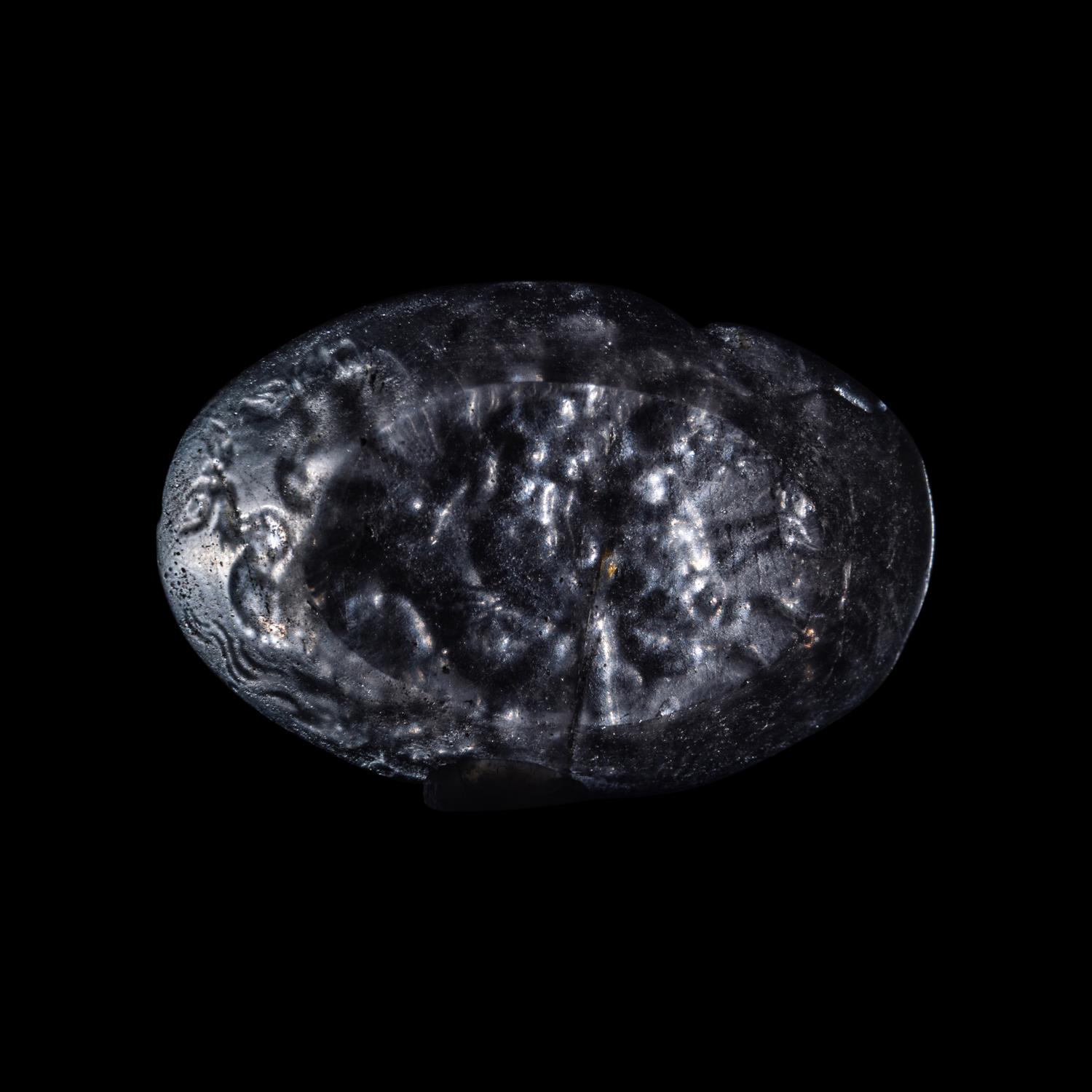 A Roman Smokey Quartz Intaglio with a Nereid Riding Two Hippocamps