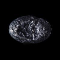 A Roman Smokey Quartz Intaglio with a Nereid Riding Two Hippocamps