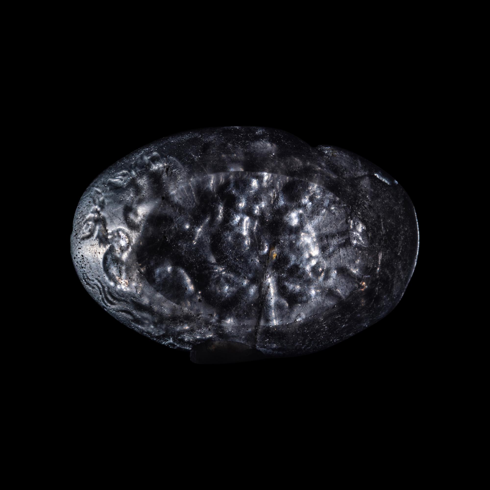 A Roman Smokey Quartz Intaglio with a Nereid Riding Two Hippocamps
