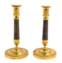 A Pair of Empire Gilt and Patinated Bronze Candlesticks Height 10 3/4 inches. — 19TH CENTURY