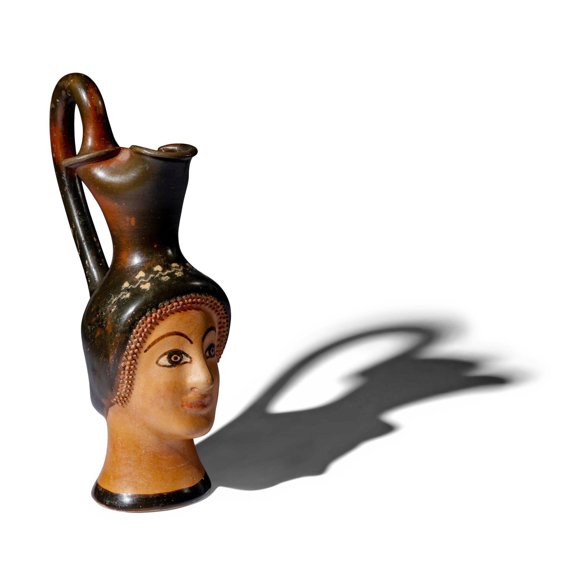 A Greek Painted Terracotta Figural Oinochoe