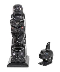 An Argillite Inuit Carving, Glen Pollard Height of the first 5 3/8 x width 1 7/8 x depth 2 1/2 inches.