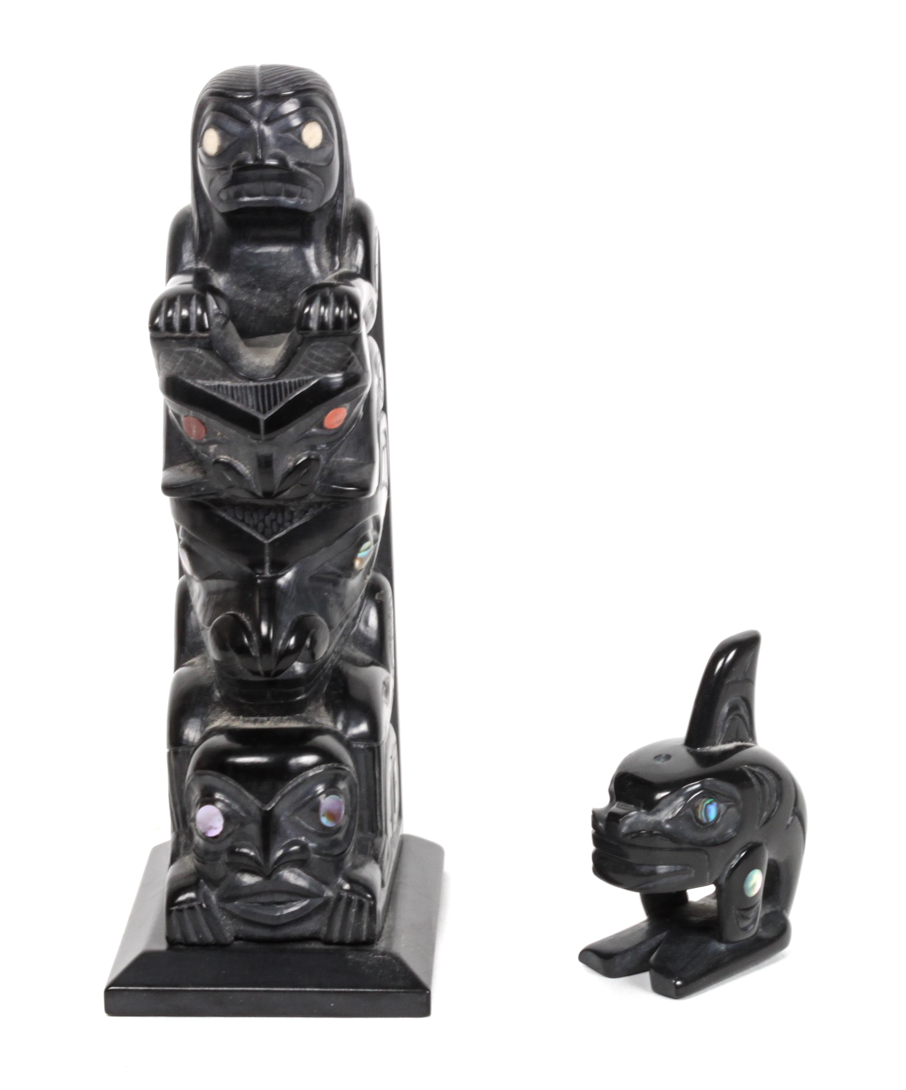 An Argillite Inuit Carving, Glen Pollard Height of the first 5 3/8 x width 1 7/8 x depth 2 1/2 inches.