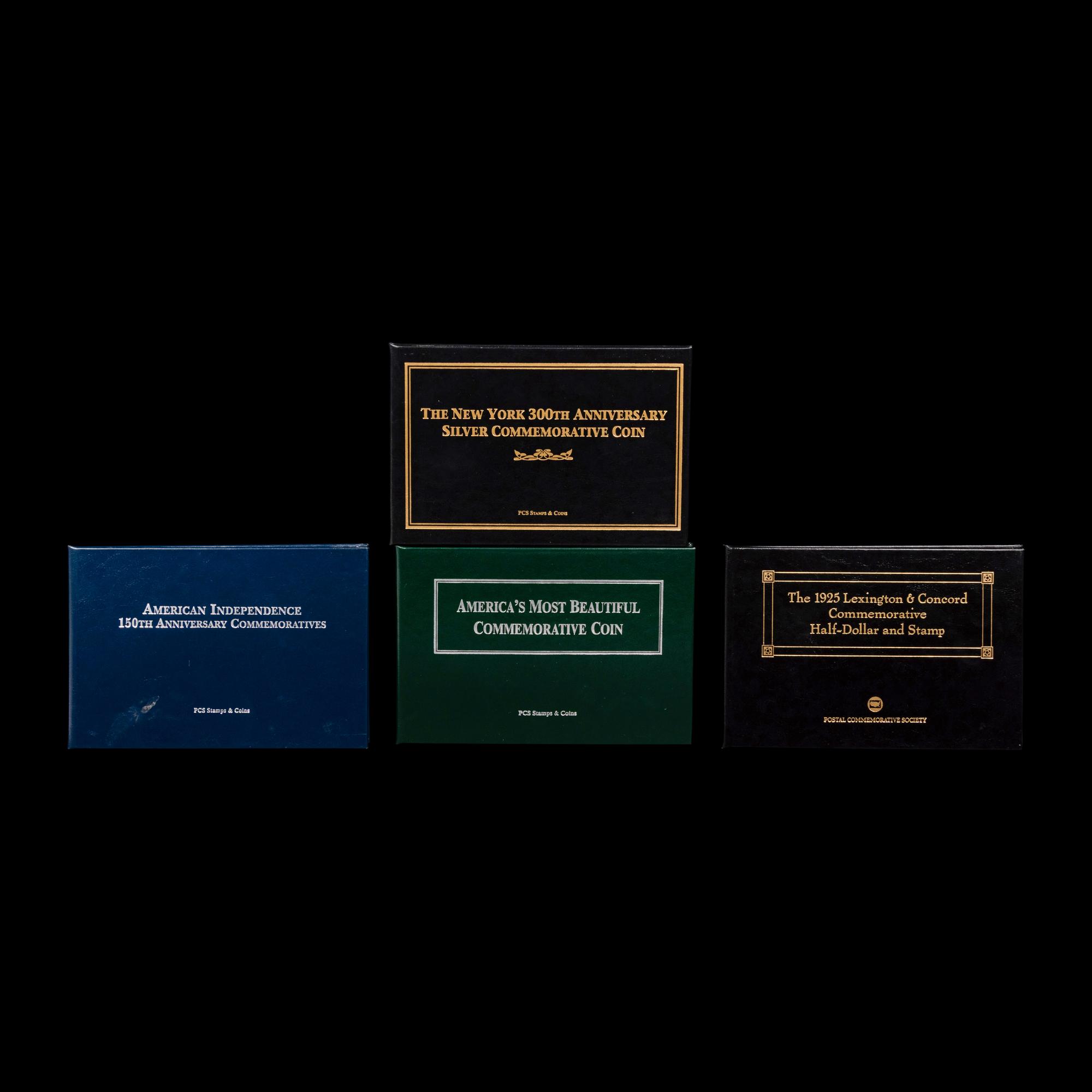 A Group of Four Commemorative 50c Coin and Stamp Sets
