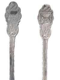 [WESTERN AMERICANA]. A group of 2 Henry Bohm silver banquet spoons commissioned by railroad magnate Otto Mears and featuring detailed mining scenes, ca 1890s.