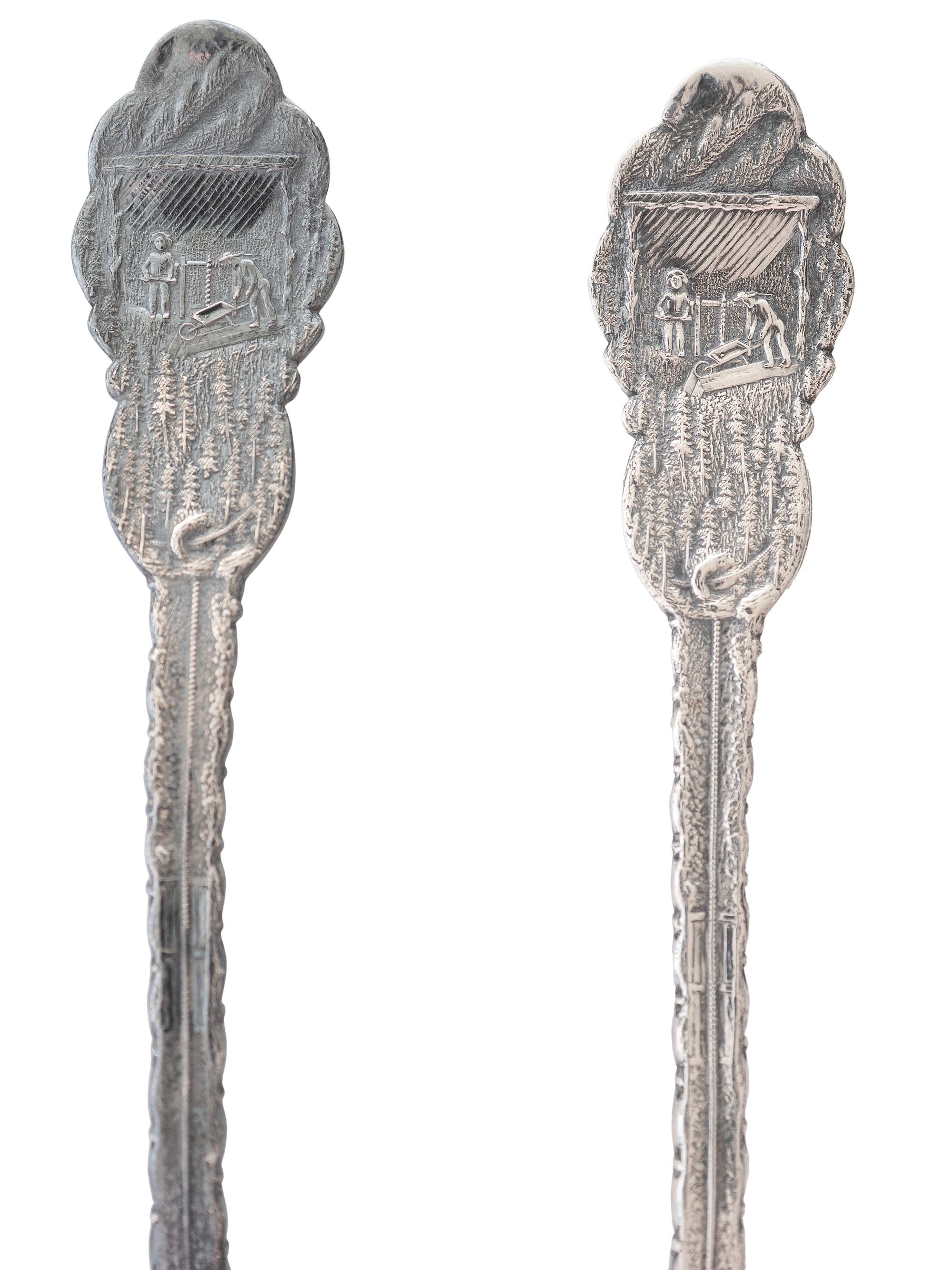 [WESTERN AMERICANA]. A group of 2 Henry Bohm silver banquet spoons commissioned by railroad magnate Otto Mears and featuring detailed mining scenes, ca 1890s.