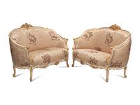 A Pair of Louis XV Style Cream-Painted and Parcel Gilt Settees