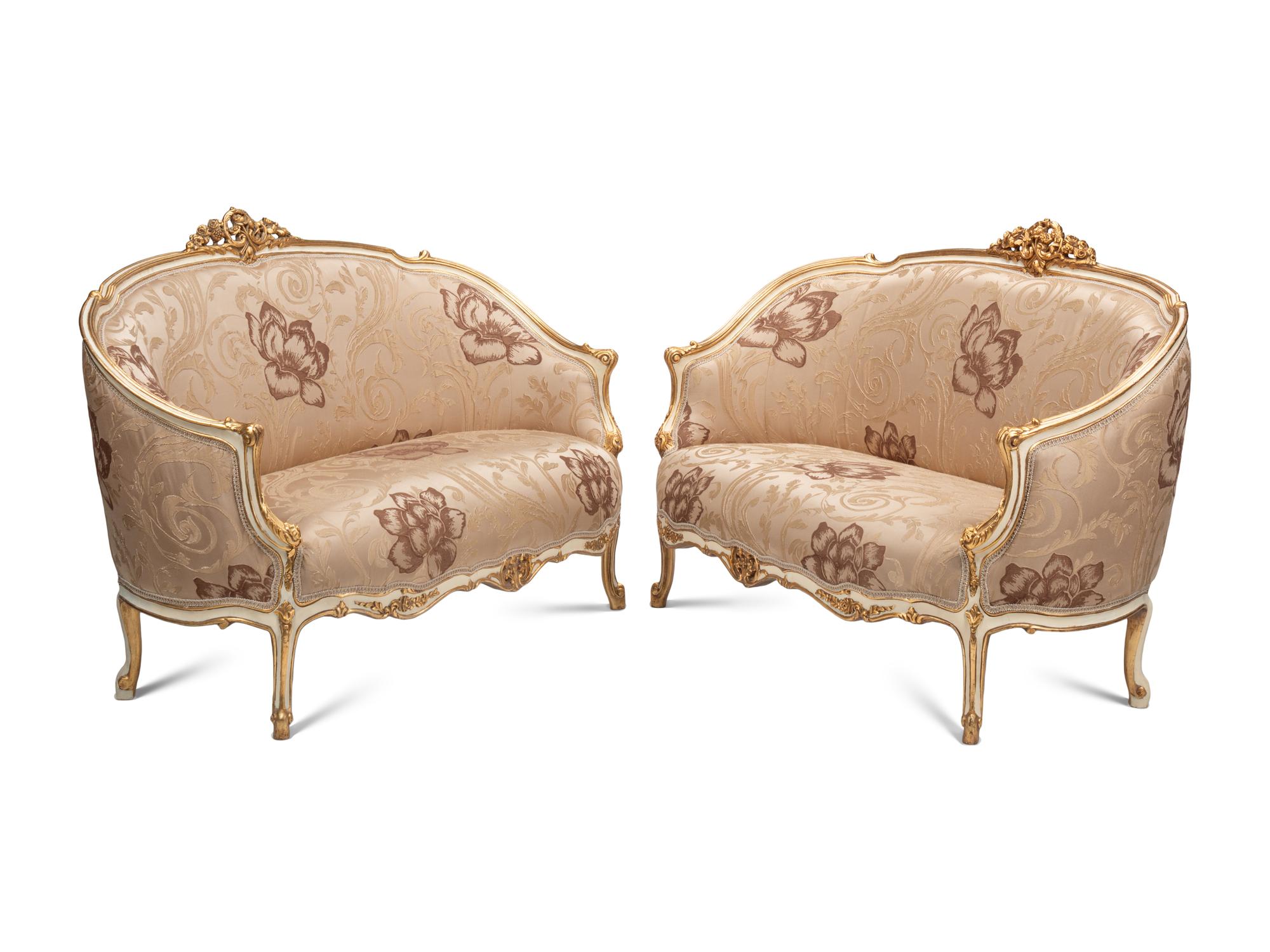 A Pair of Louis XV Style Cream-Painted and Parcel Gilt Settees