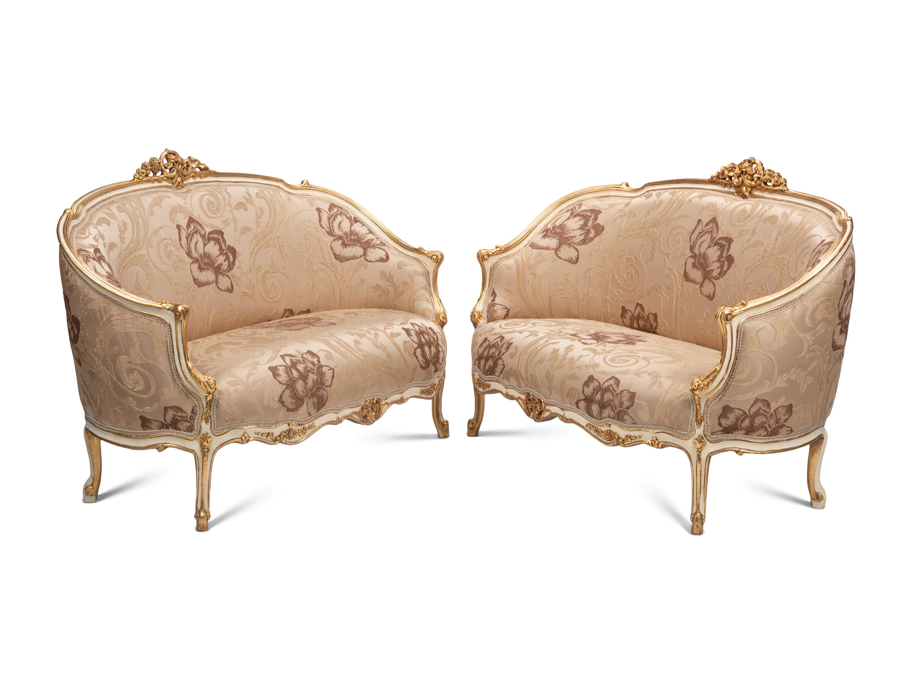 A Pair of Louis XV Style Cream-Painted and Parcel Gilt Settees