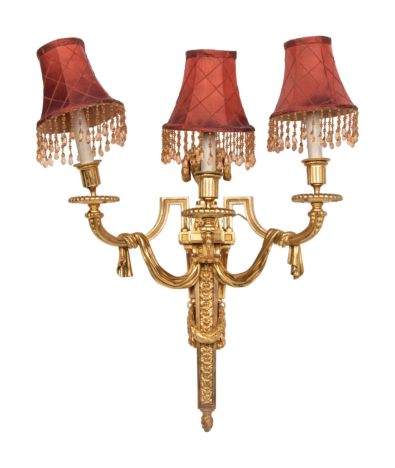 A Set of Four Louis XVI Style Gilt-Bronze Three-Light Sconces