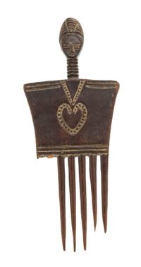 An Baule Carved Wood Comb Height 8 x width 3 1/4 x depth 1/4 inches.