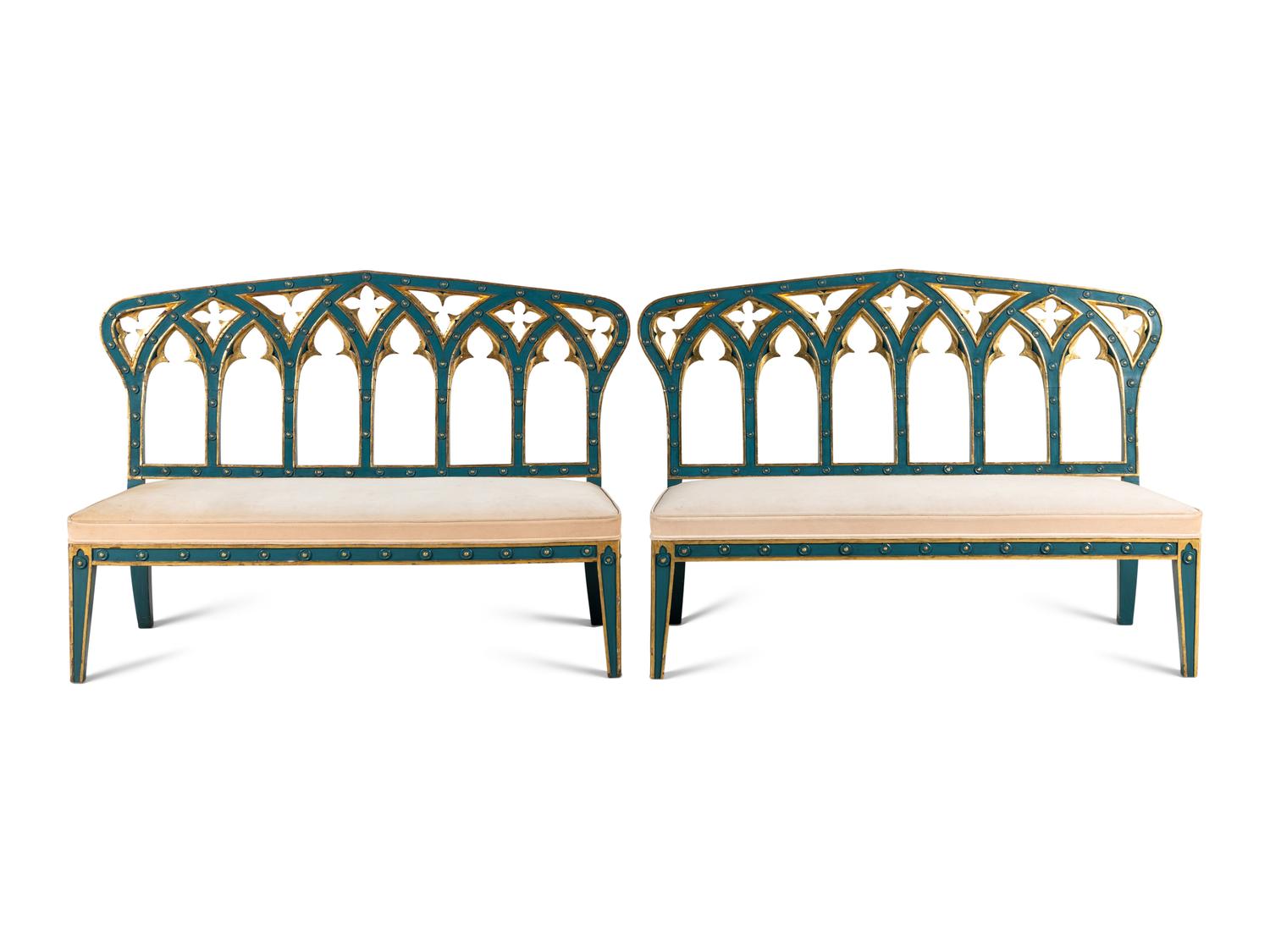 A Pair of English Gothic Revival Painted and Parcel Gilt Settees