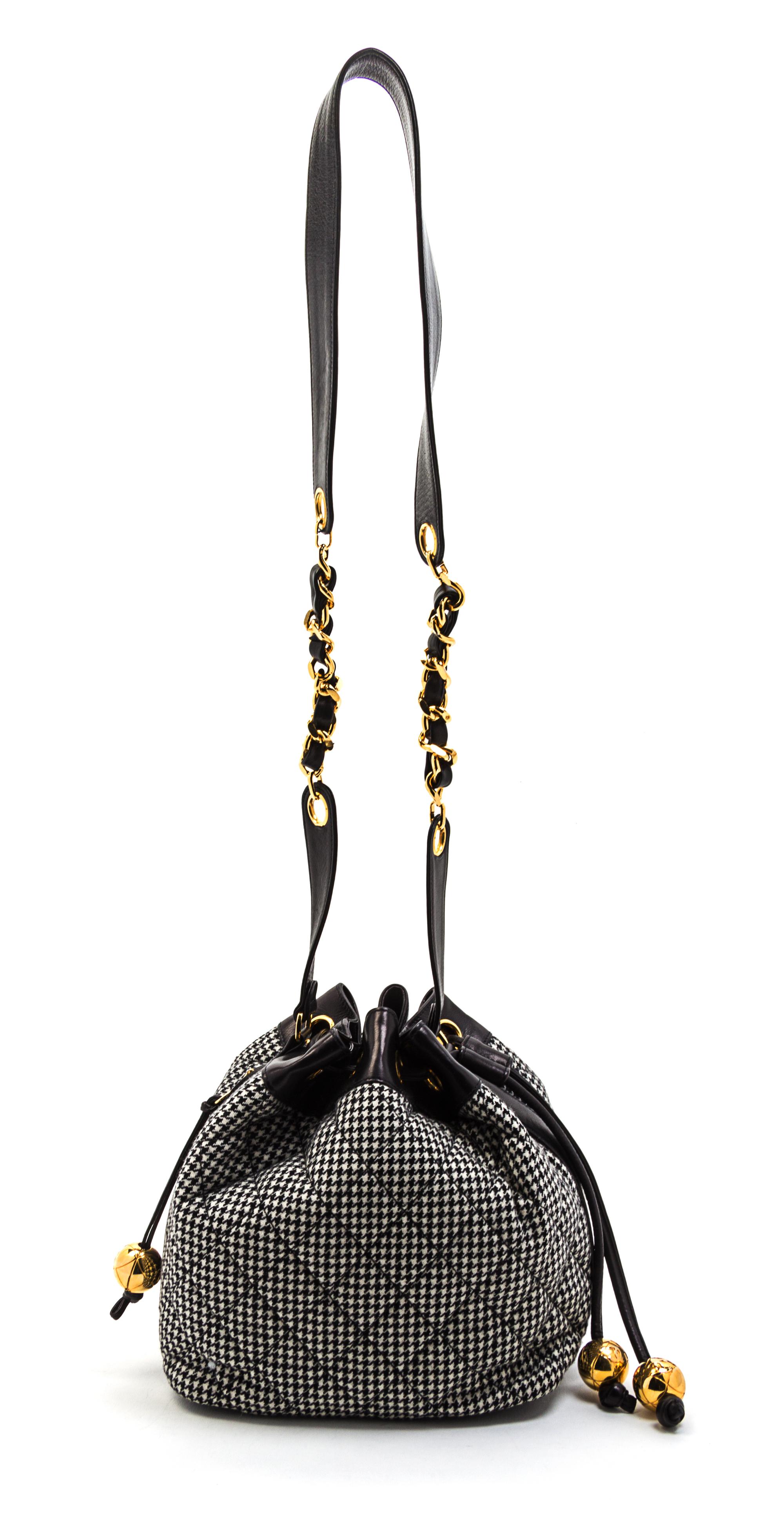 A Chanel Black and White Houndstooth Wool and Black Leather Trim Bucket Bag, 8 1/2 x 7 1/2 x 5 1/2 inches.