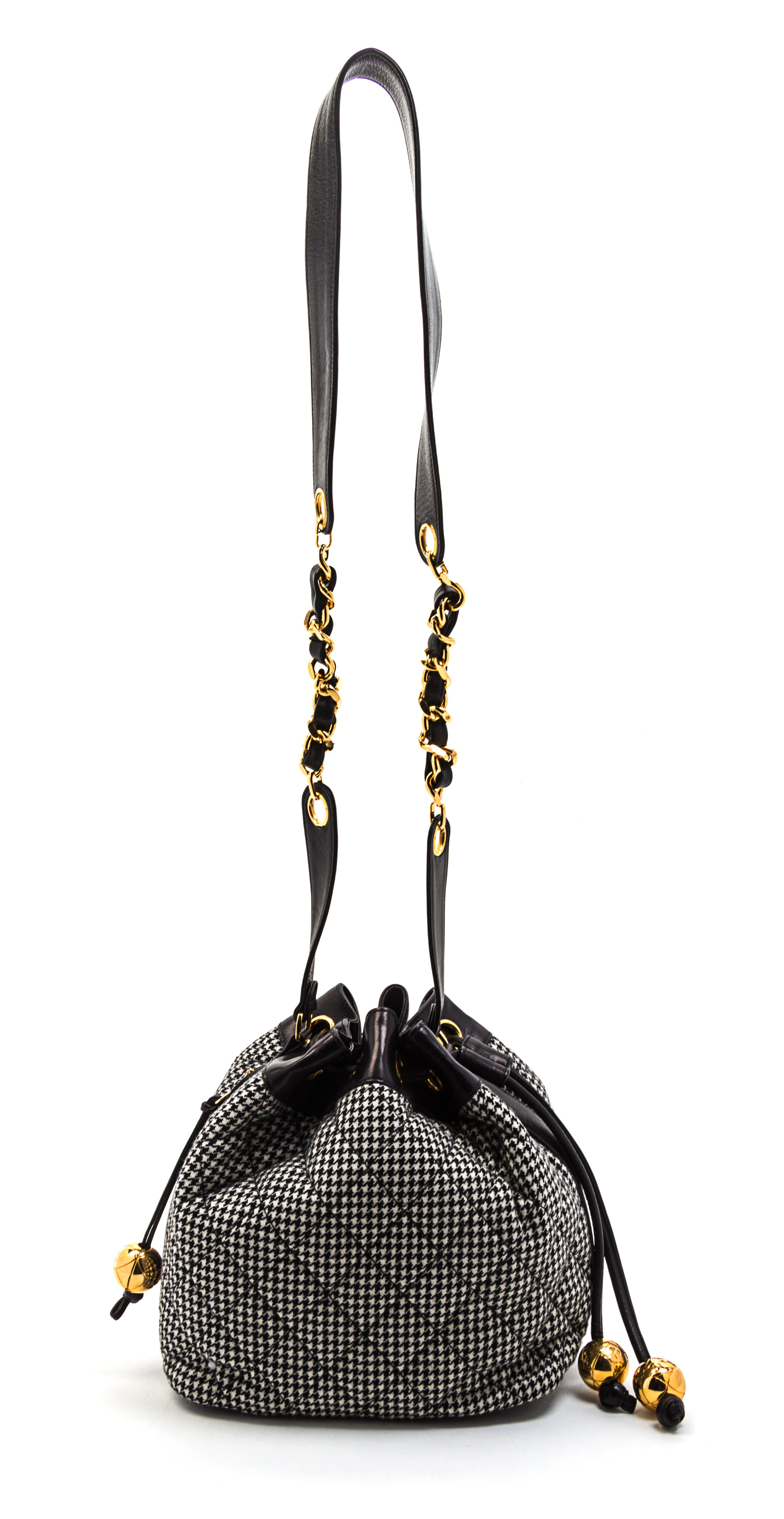 A Chanel Black and White Houndstooth Wool and Black Leather Trim Bucket Bag, 8 1/2 x 7 1/2 x 5 1/2 inches.