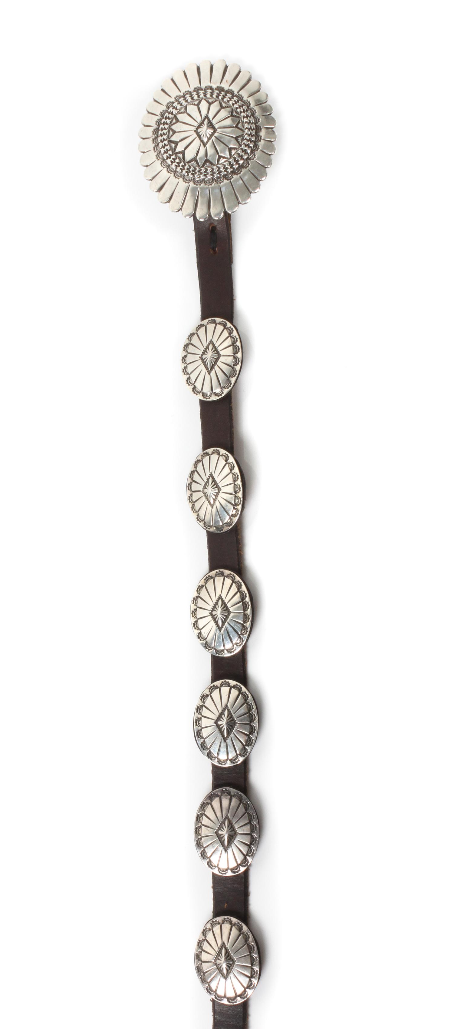 A James Reid Ltd., Santa Fe, NM, Silver and Leather Concha Belt Height of 2 1/4 x width 2 3/4, belt length 38 inches.