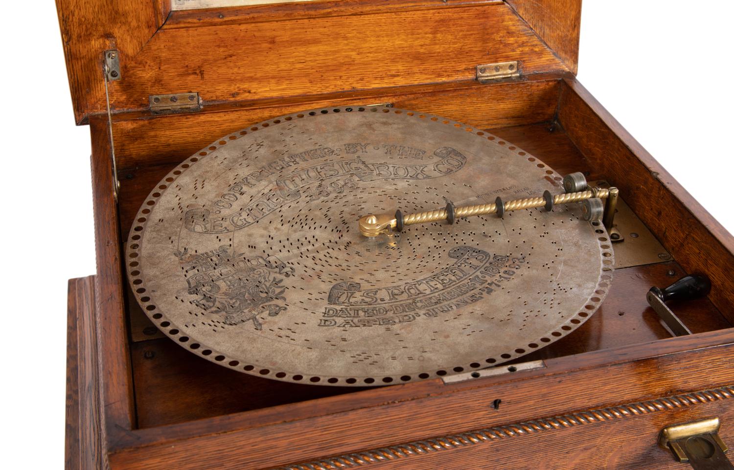 A Regina Coin Operated 15 1/2 Inch Disc Music Box and Stand