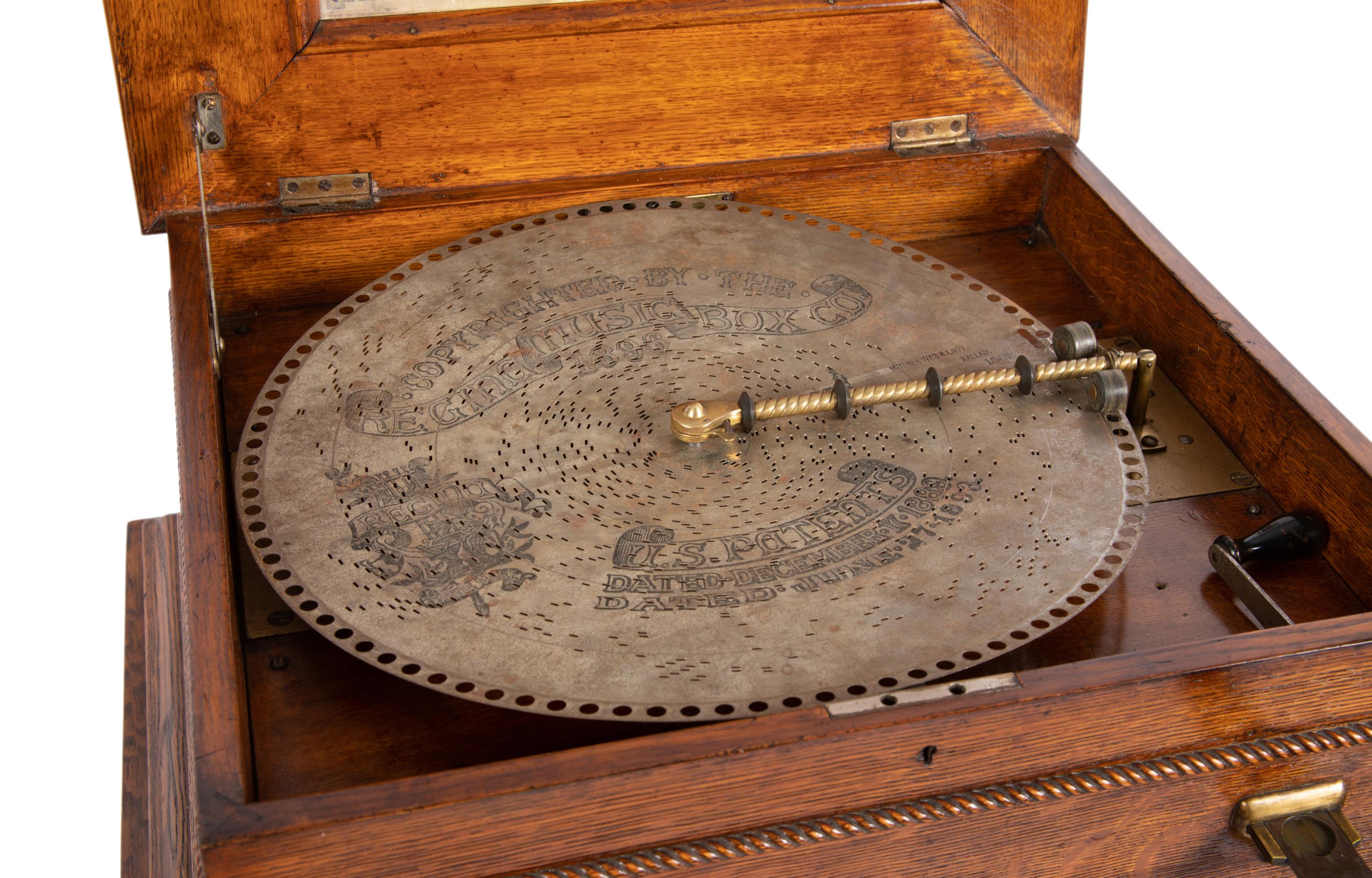 A Regina Coin Operated 15 1/2 Inch Disc Music Box and Stand