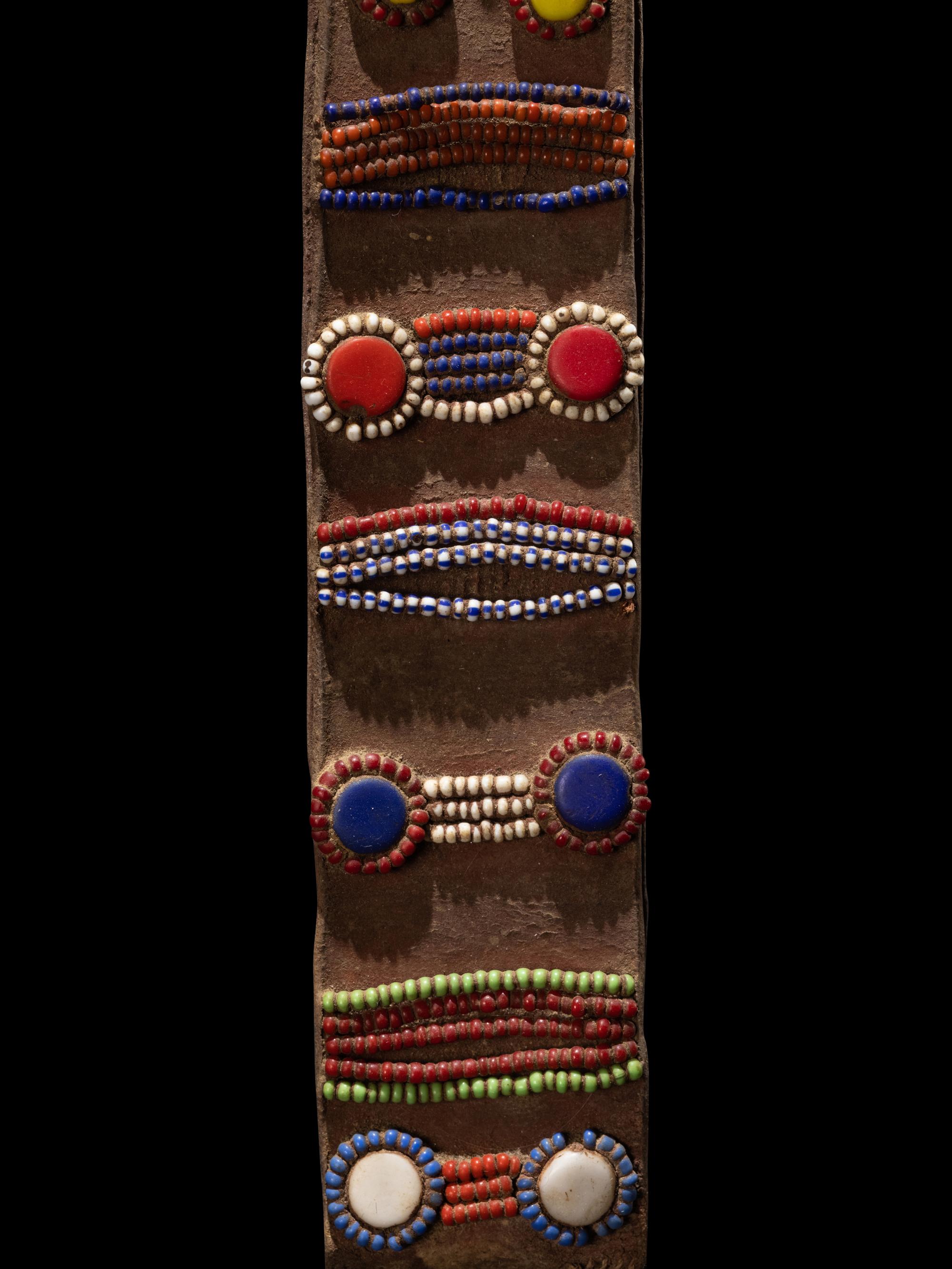 A Maasai Leather Hoop Decorated With Beads