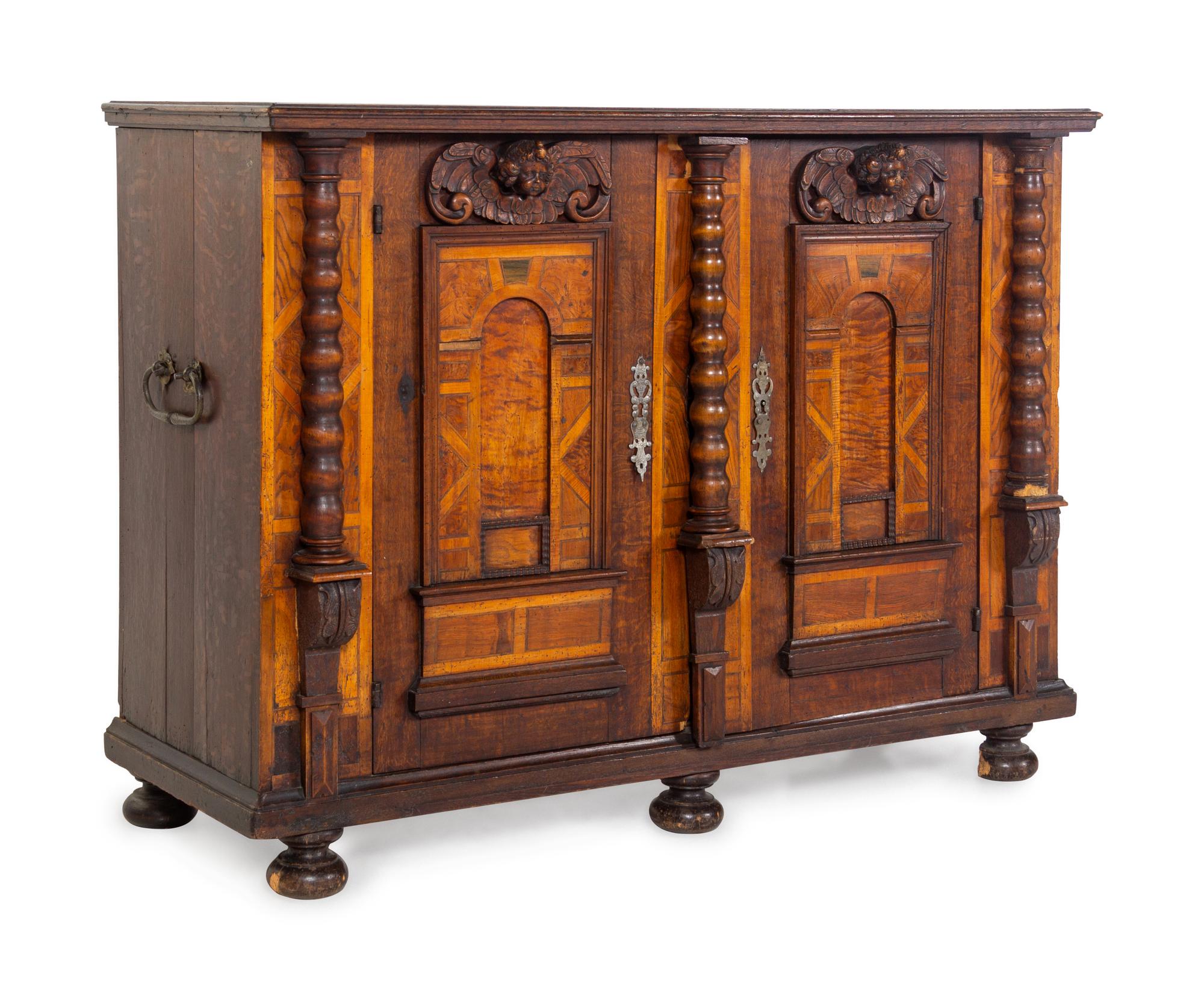 A German Carved Walnut and Parquetry Cabinet