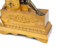 An Empire Gilt and Patinated Bronze Figural Mantel Clock