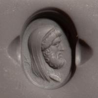 A Roman Carnelian Ring Stone with a Portrait Head of the God Cronus — Set in a gold ring