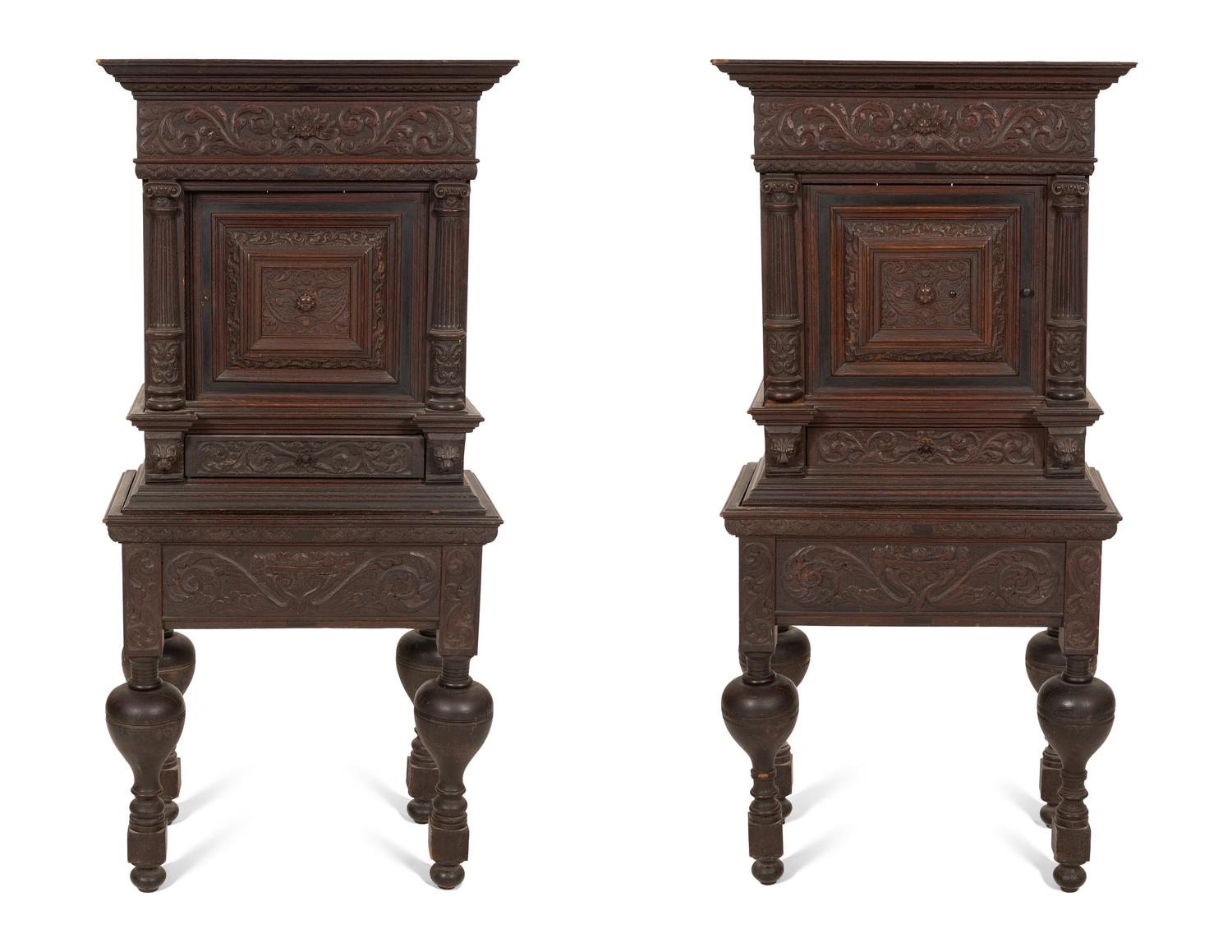 A Pair of Continental Carved Oak Cabinets on Stands