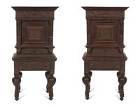 A Pair of Continental Carved Oak Cabinets on Stands