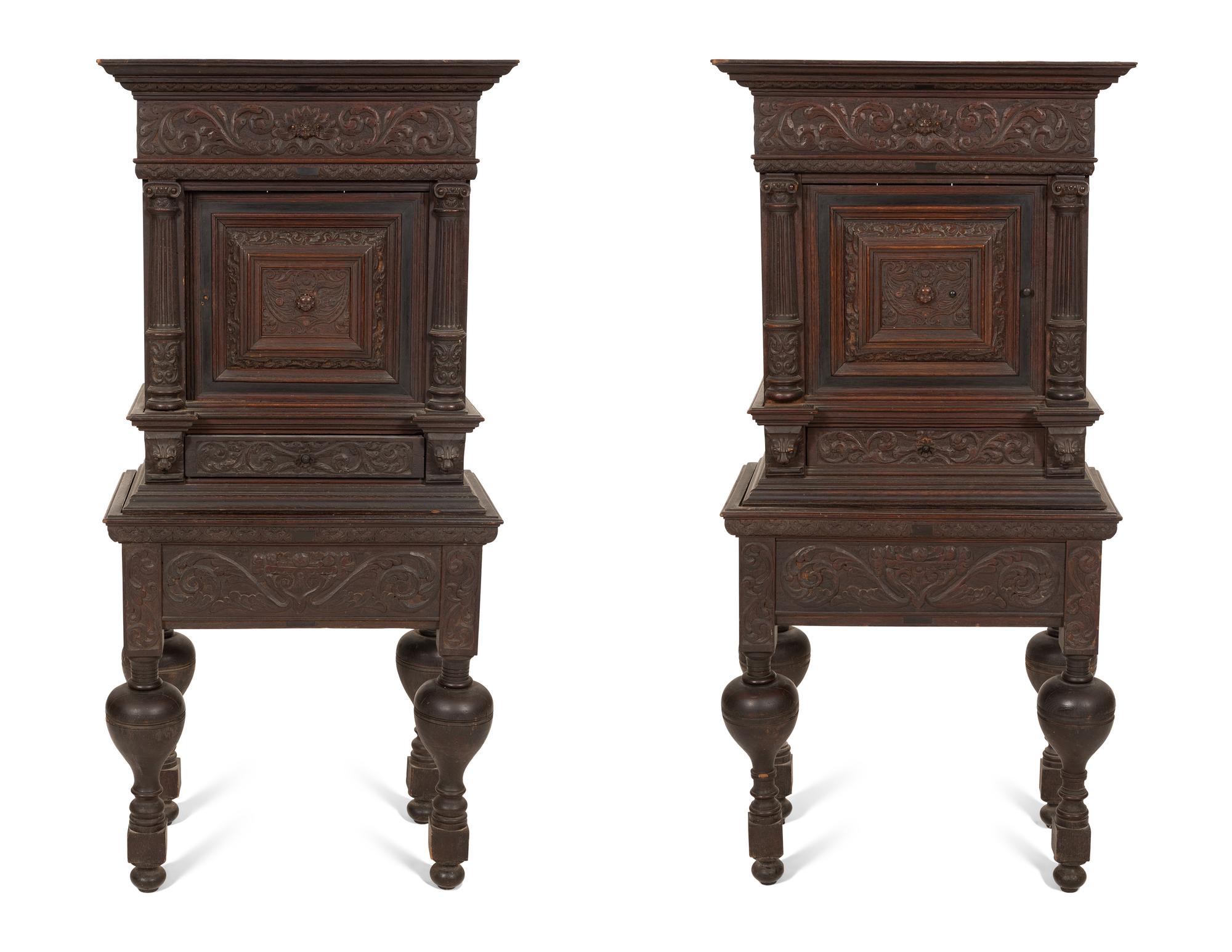 A Pair of Continental Carved Oak Cabinets on Stands