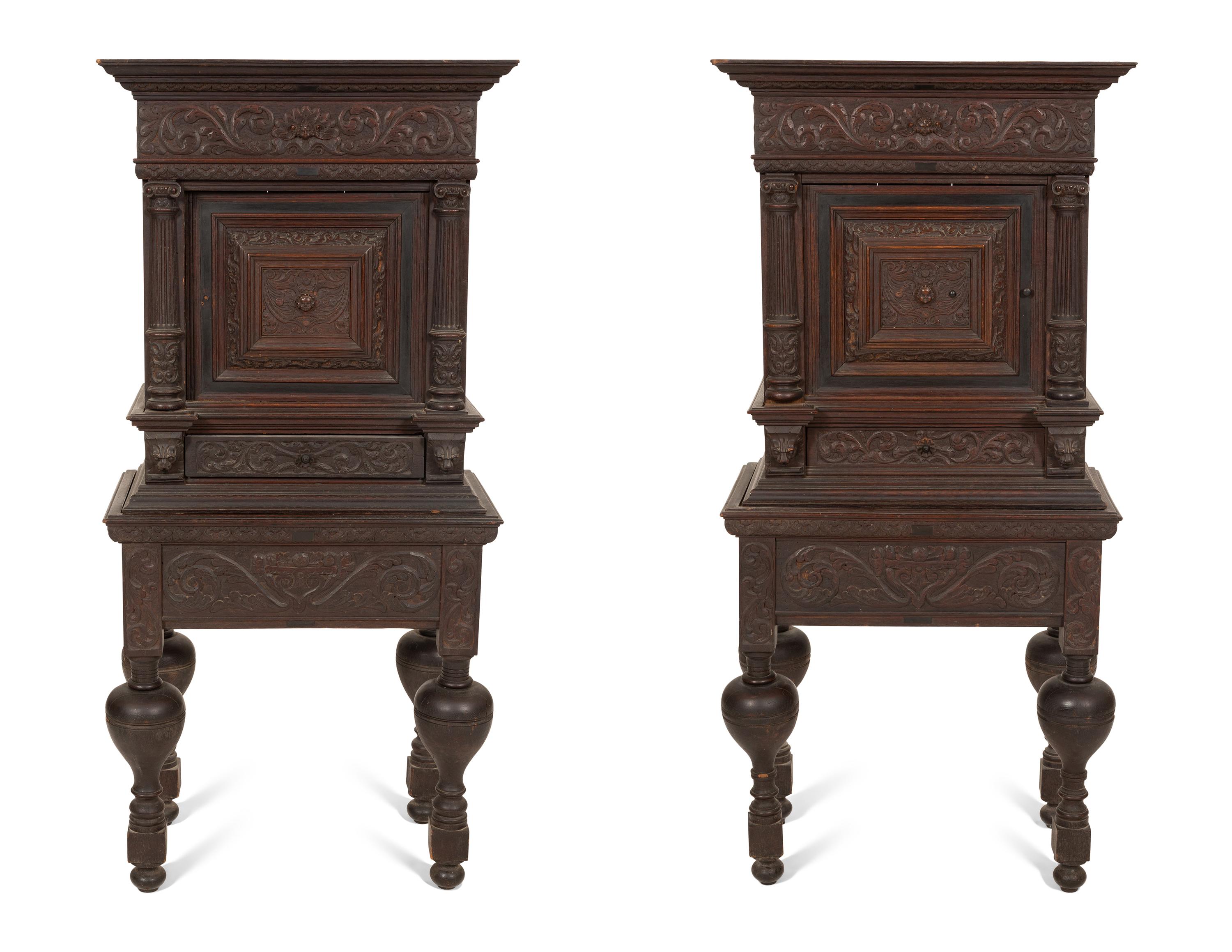 A Pair of Continental Carved Oak Cabinets on Stands