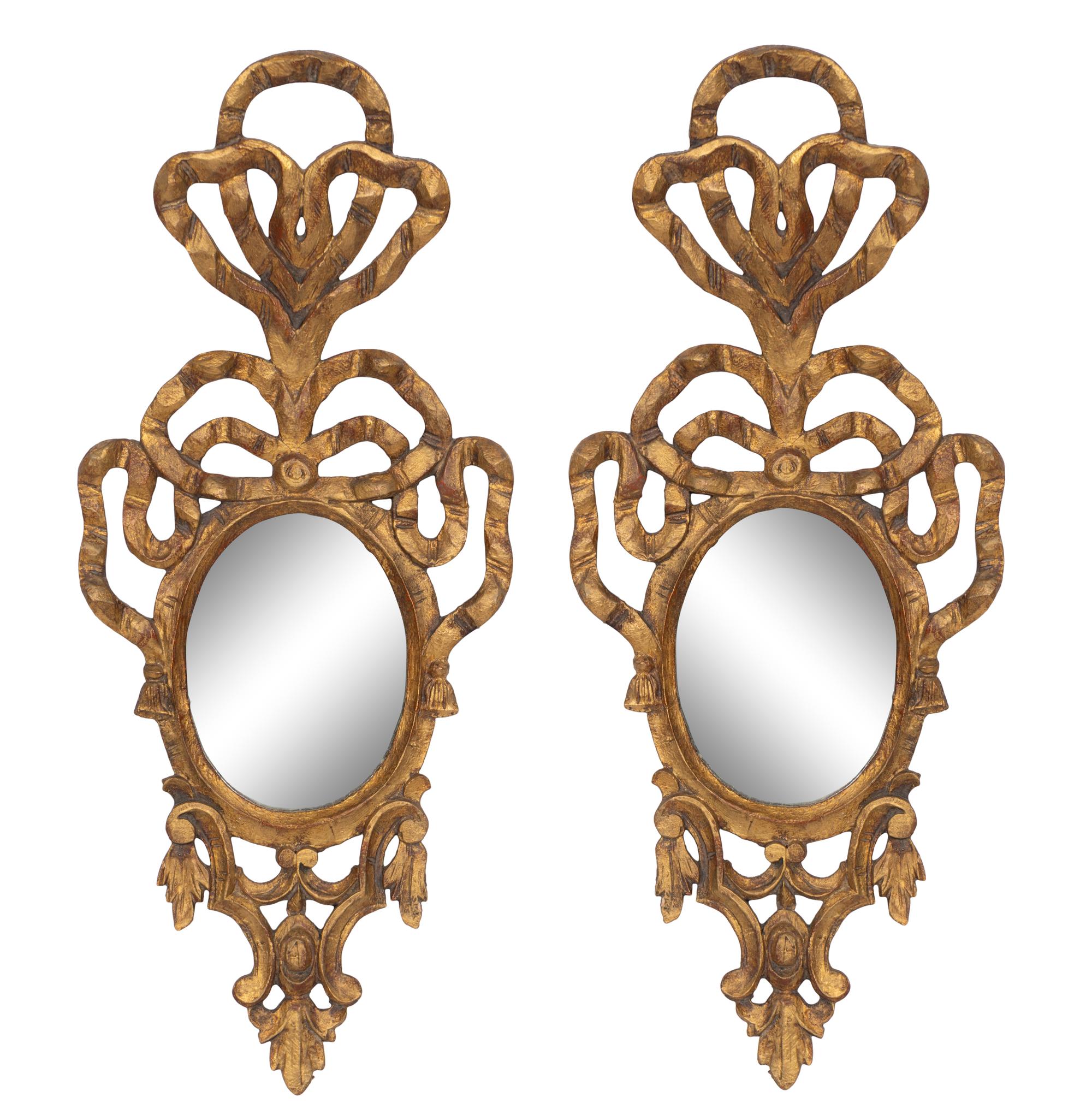 A Pair of Italian Giltwood Ribbon-Tied Oval Mirrors