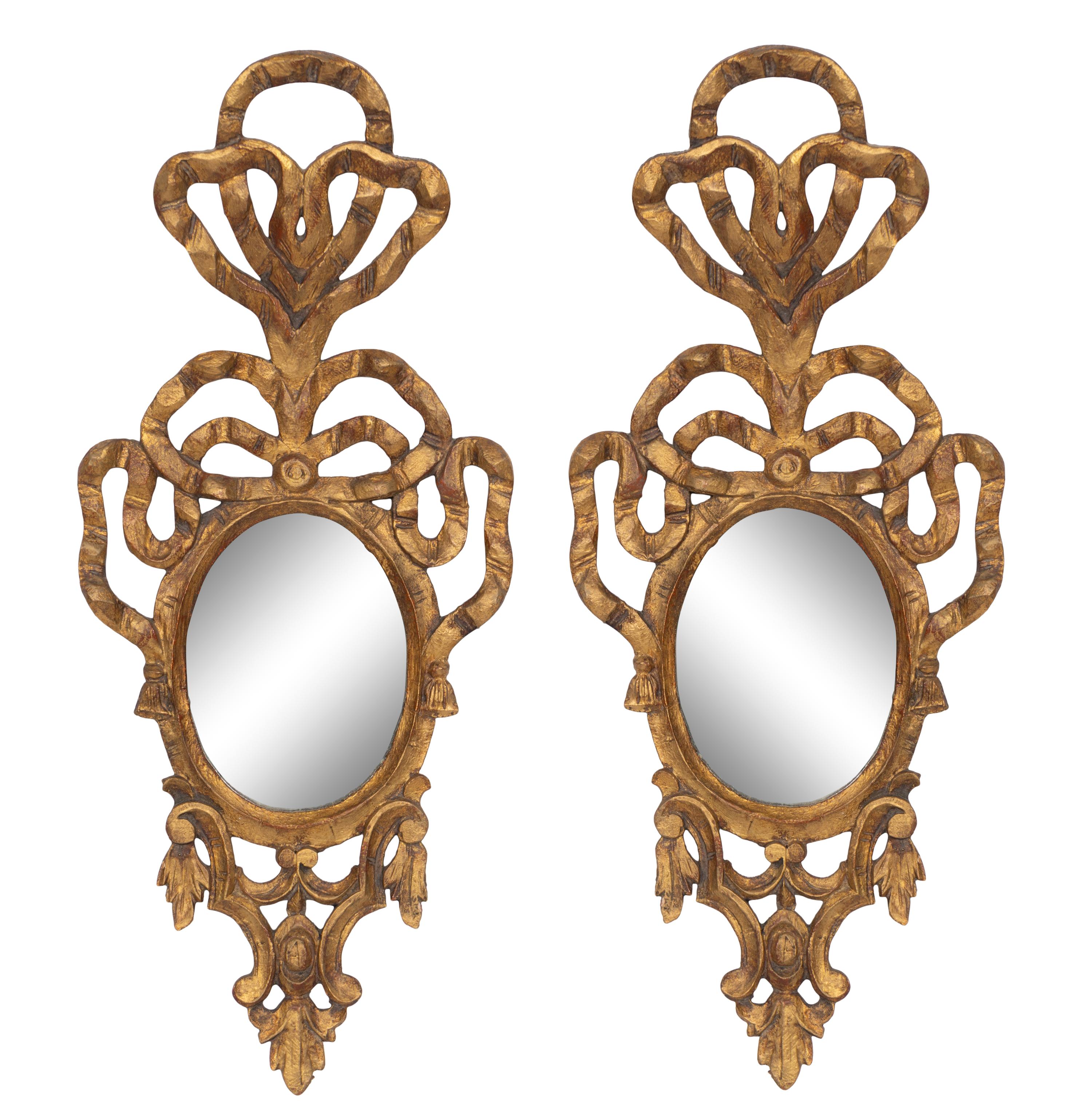 A Pair of Italian Giltwood Ribbon-Tied Oval Mirrors
