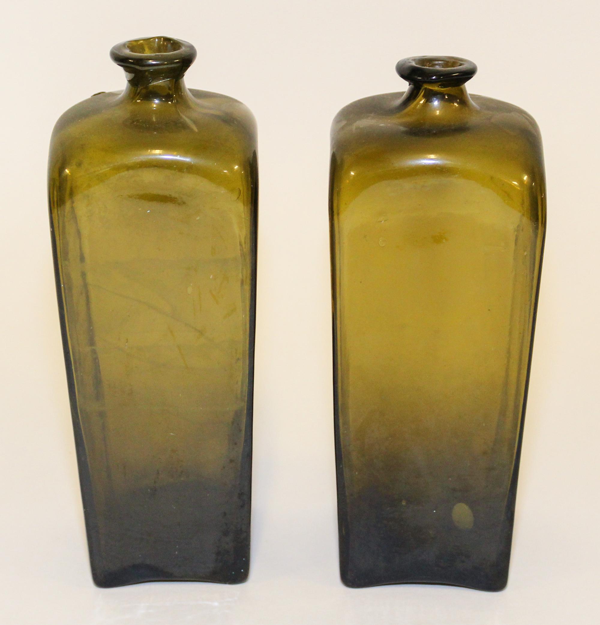 A Pair of English Green Glass Gin or Case Bottles Height of taller 10 1/4 inches. — EARLY 19TH CENTURY