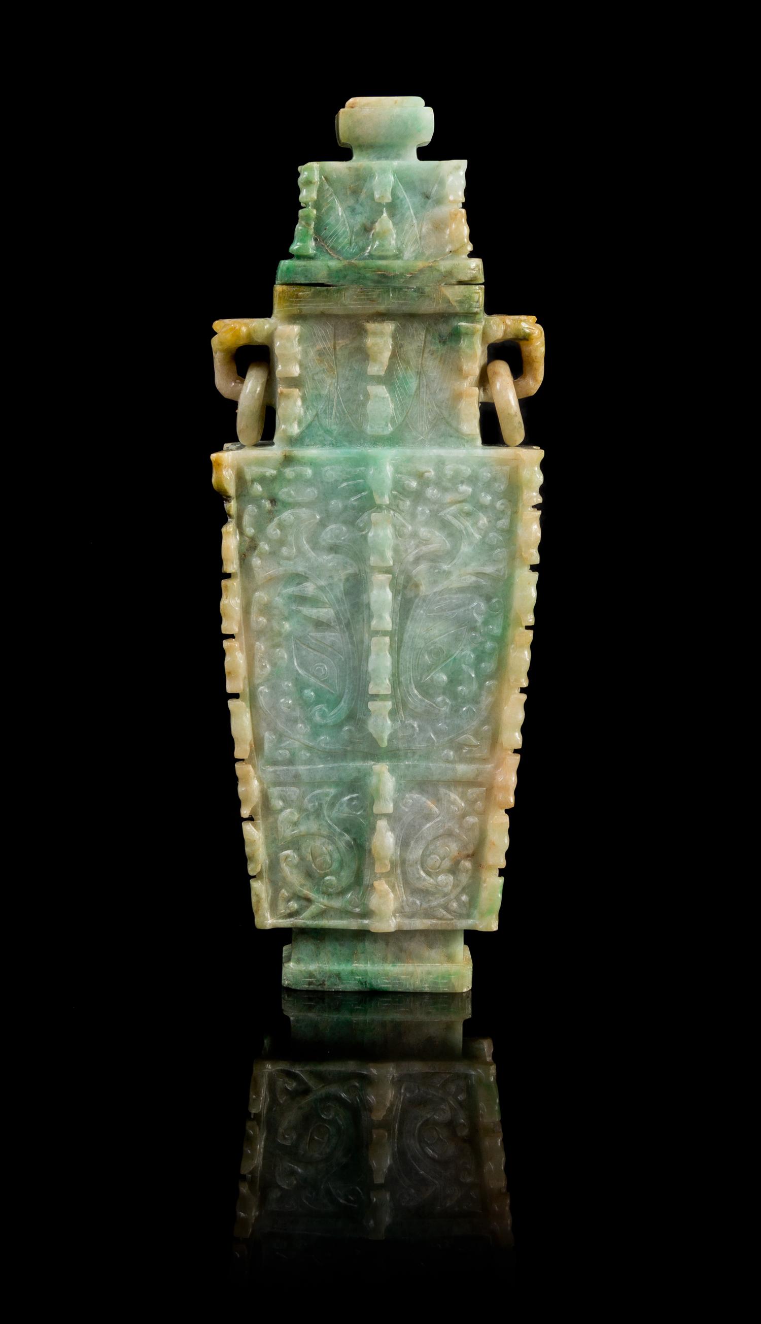 A Chinese Archaistic Jadeite Covered Vase LATE 19TH/EARLY 20TH CENTURY Height 9 3/8 x width 3 3/8 inches. — LATE 19TH/EARLY 20TH CENTURY