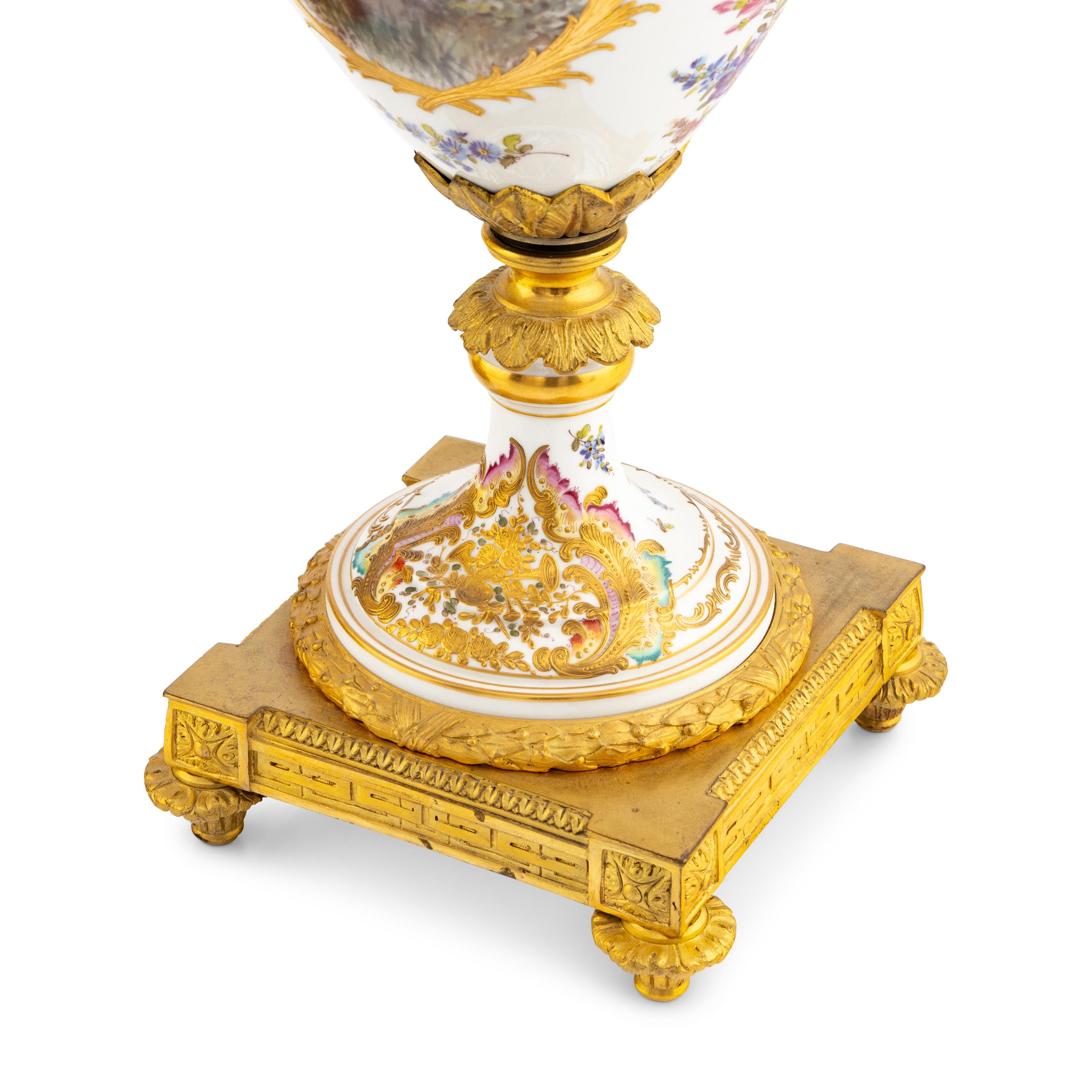 A Pair of Sèvres Style Porcelain and Gilt Bronze Mounted Urns