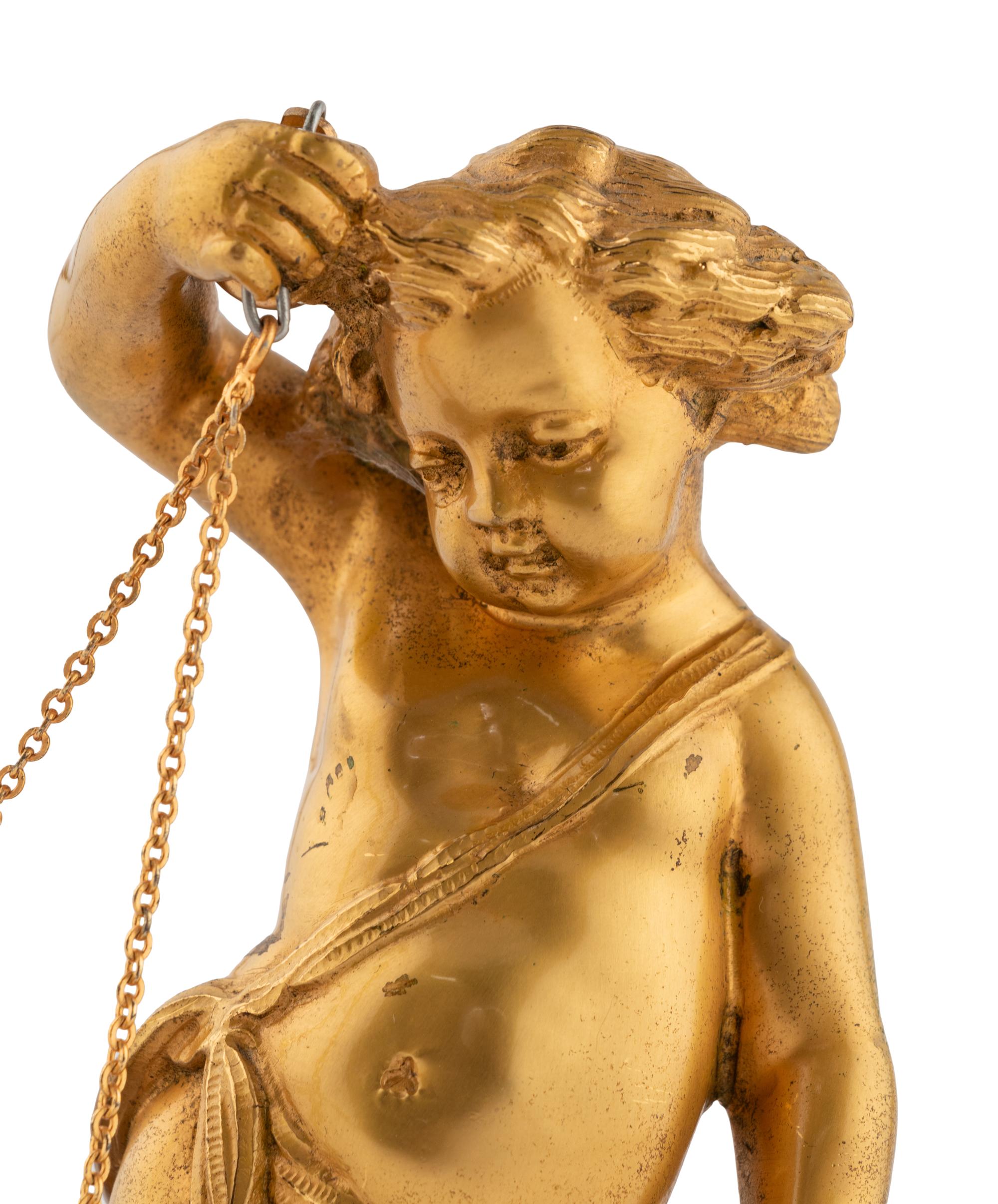 A Continental Gilt Bronze and Marble Figural Clock