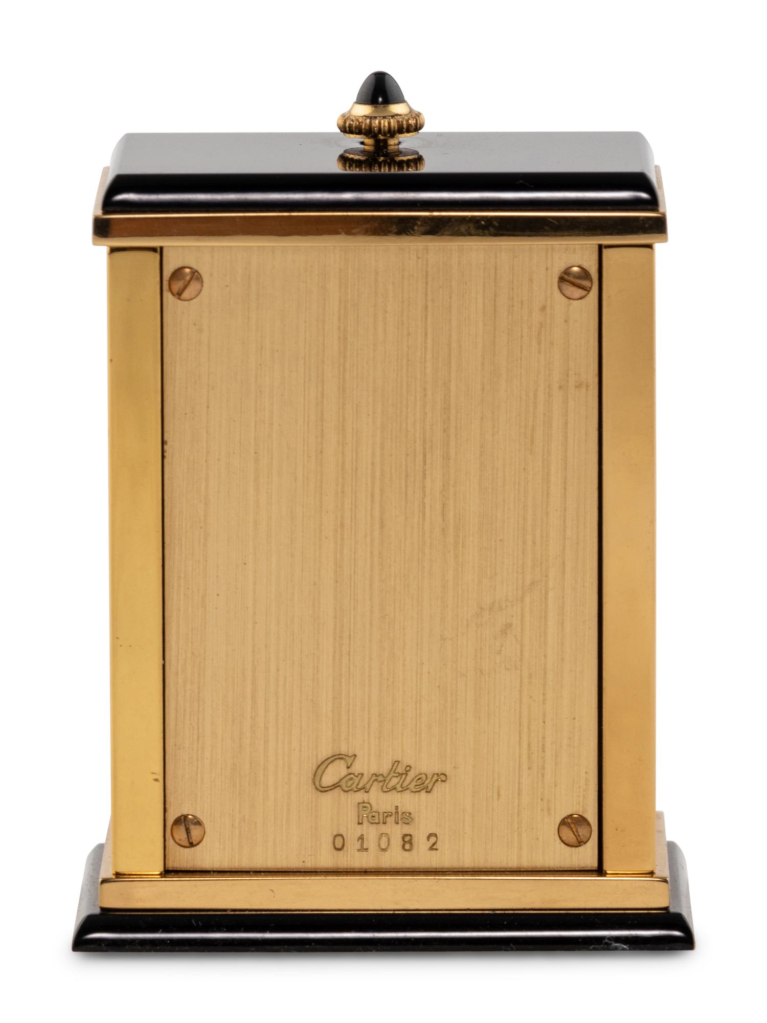 A Cartier Engraved Brass and Onyx Travel Clock