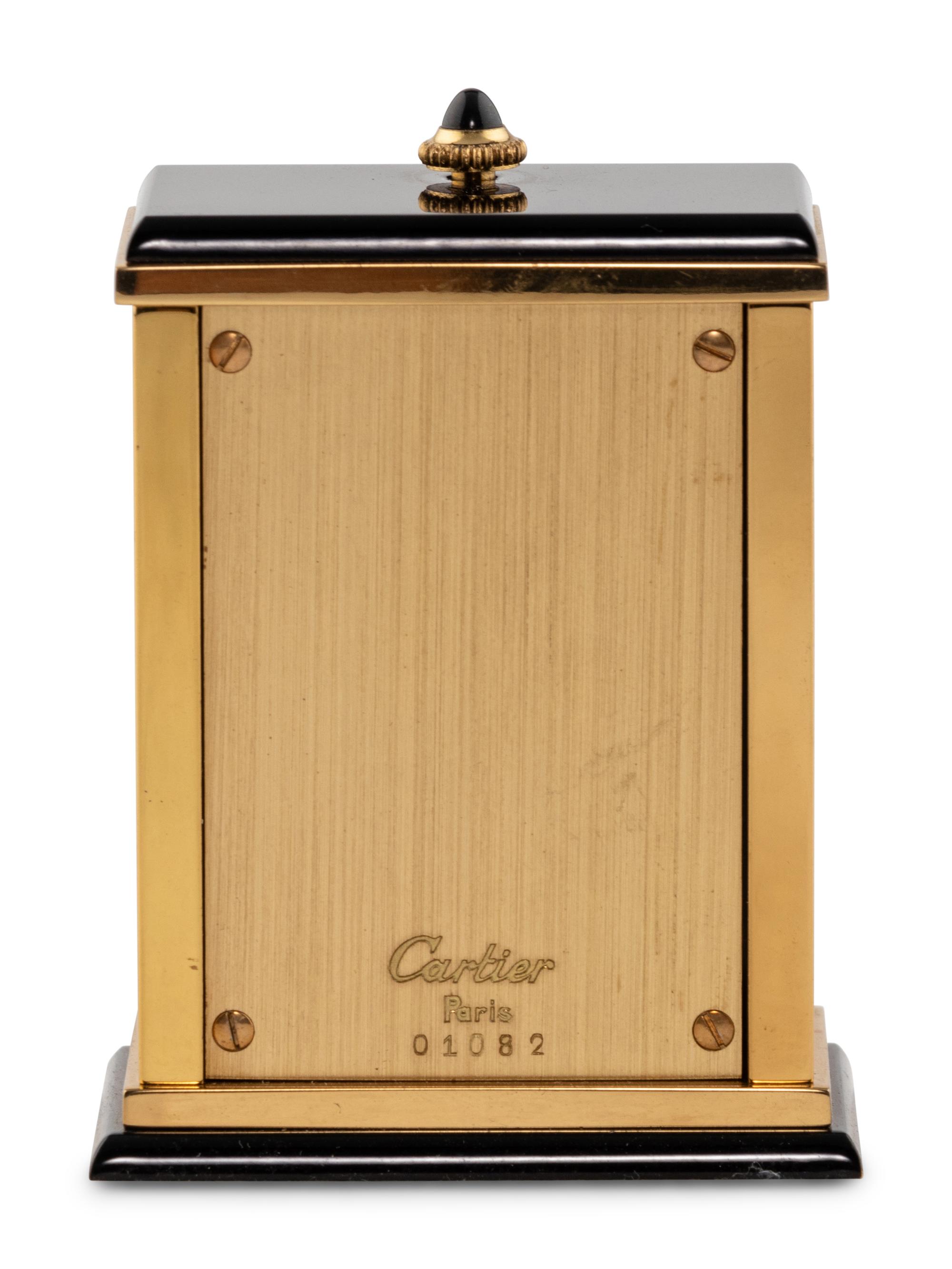 A Cartier Engraved Brass and Onyx Travel Clock