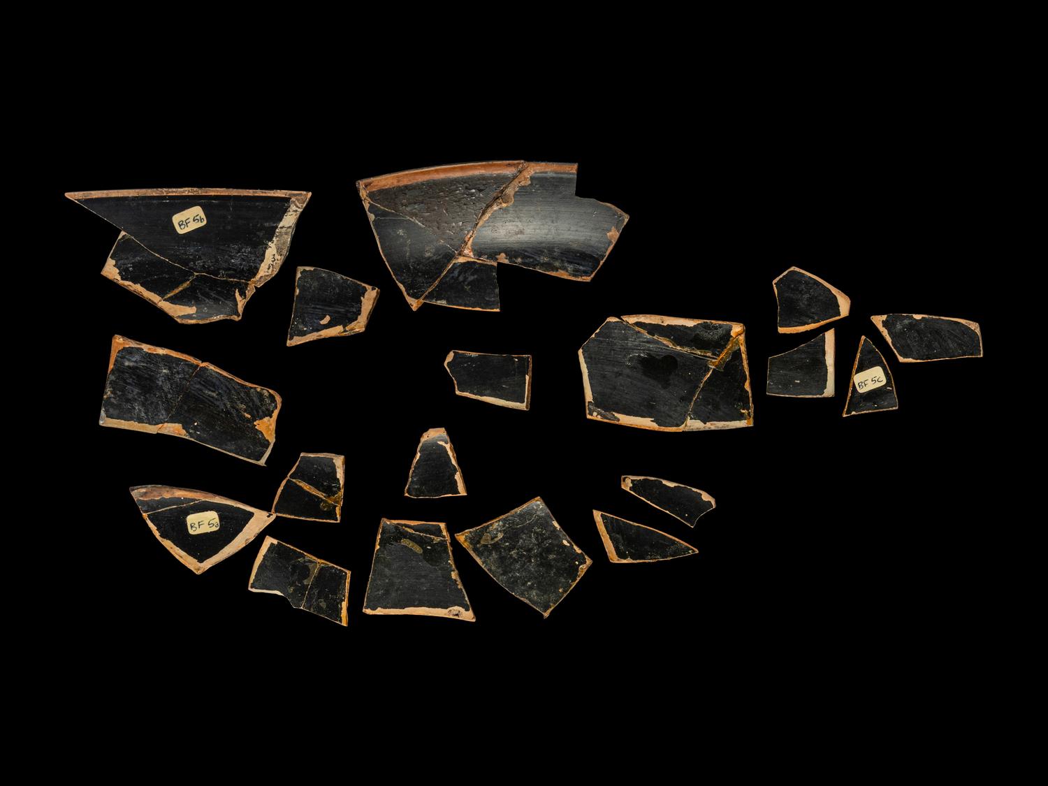 18 Attic Black-Figured Band Cup Fragments with Warriors and Sphinxes