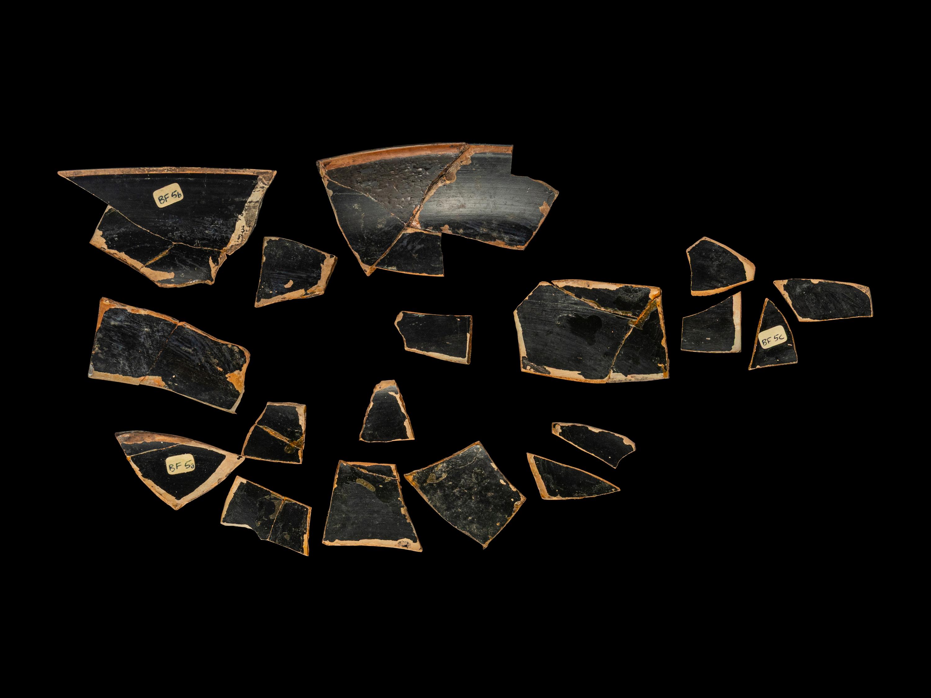 18 Attic Black-Figured Band Cup Fragments with Warriors and Sphinxes
