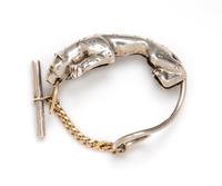 A Sterling Silver, Yellow Gold and Green Gemstone Jaguar Bracelet, 34.00 dwts.